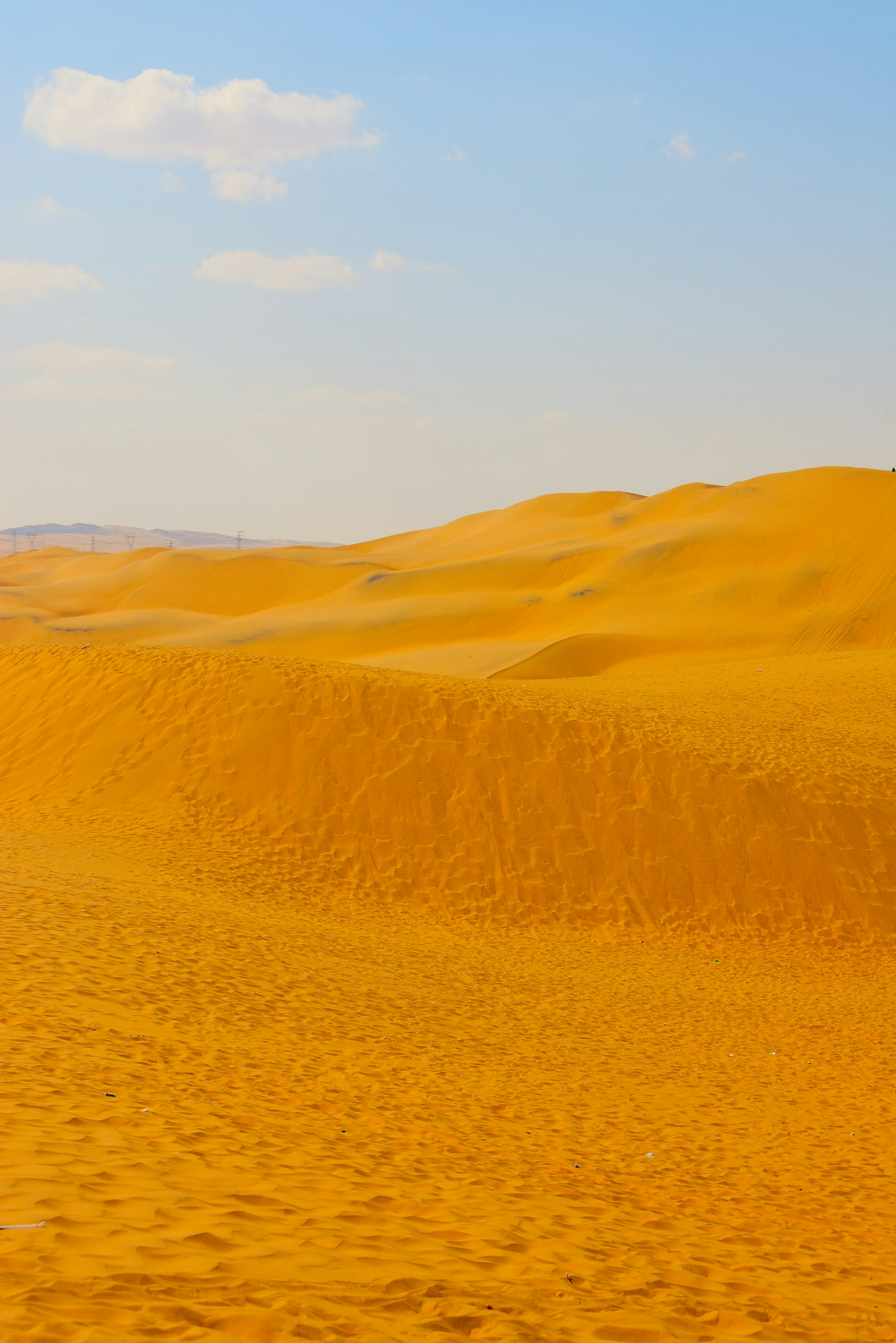 Weite orange Sanddünen unter einem blauen Himmel