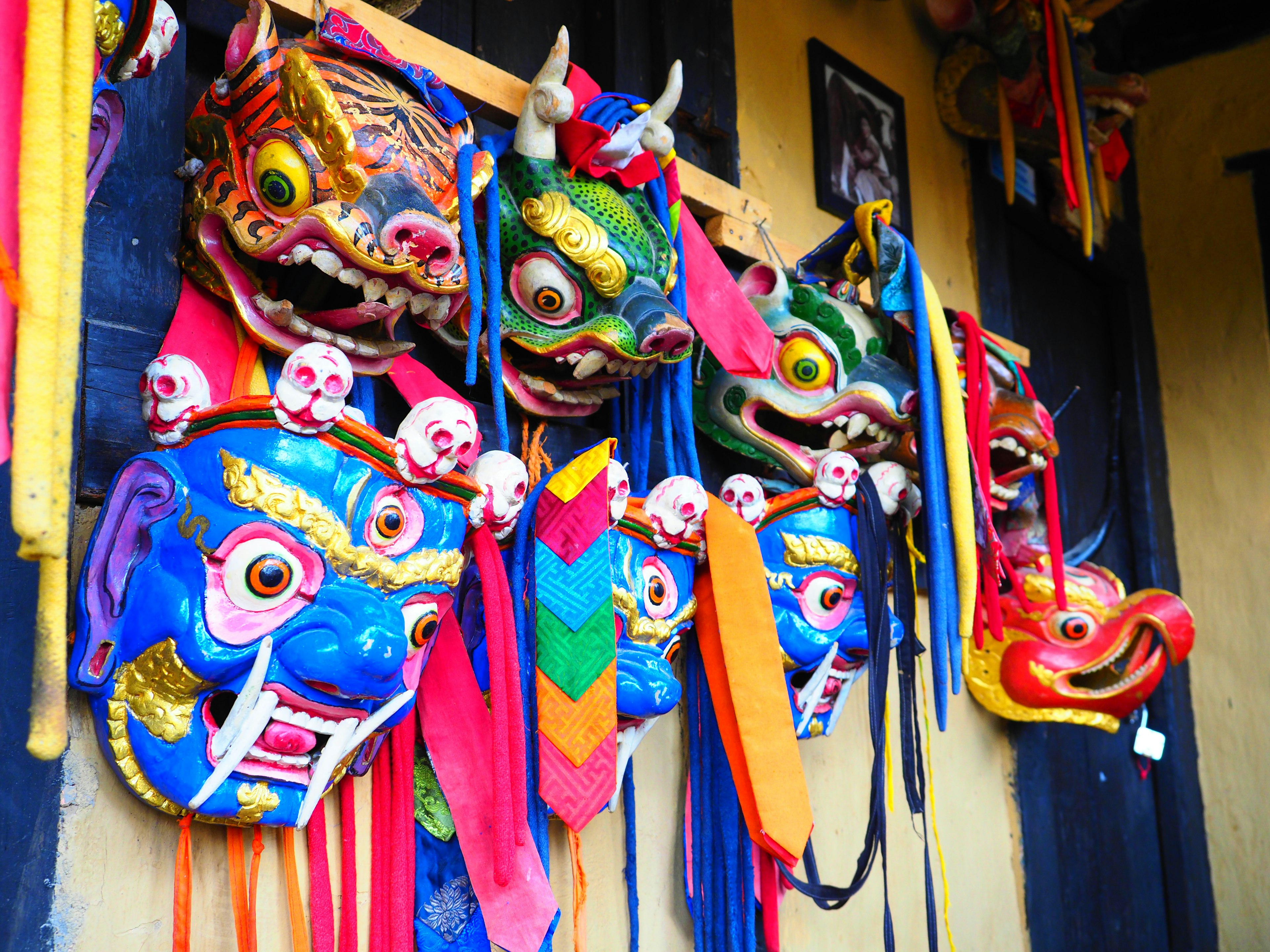 Colorful traditional Balinese masks hanging on a wall