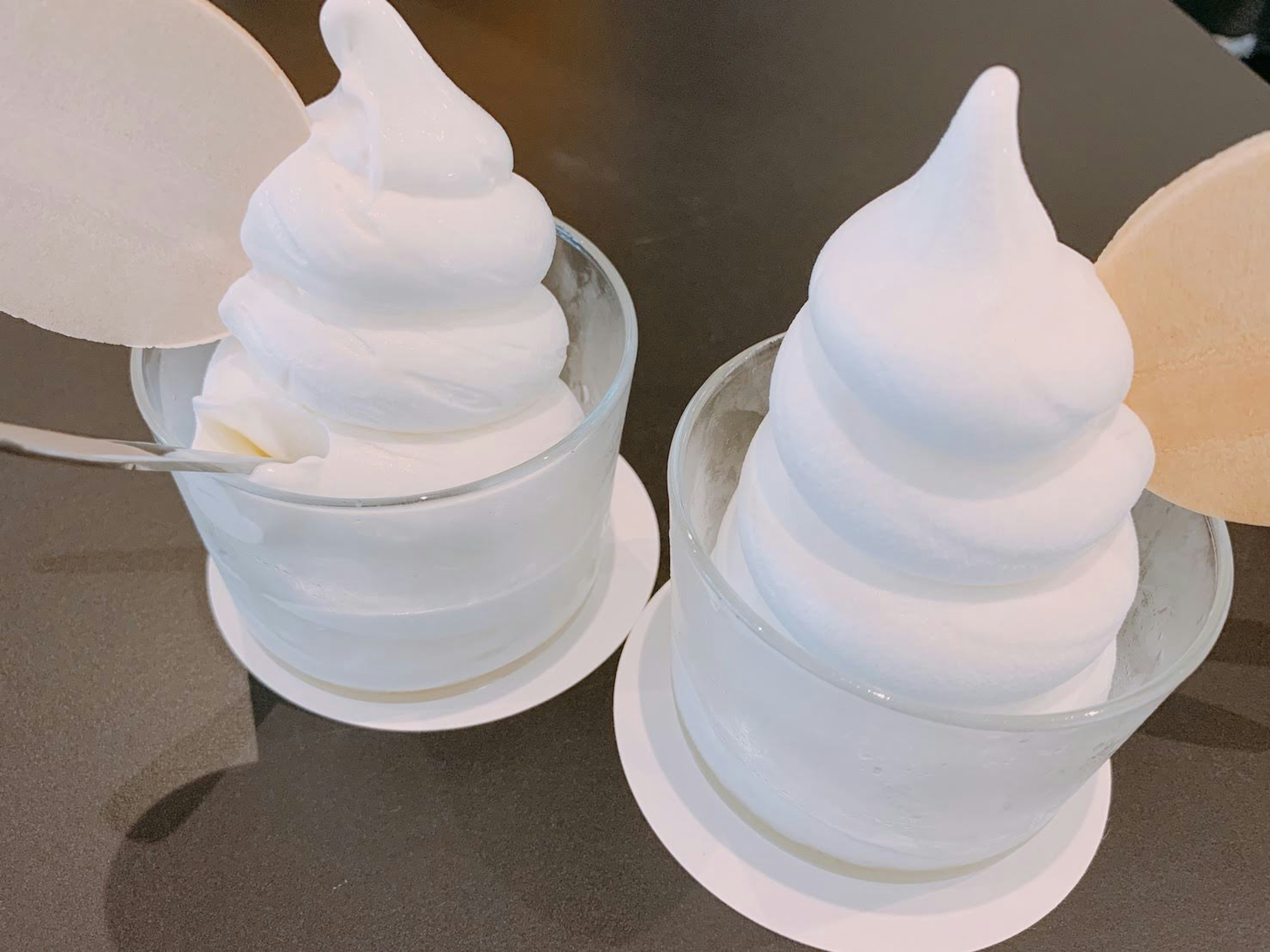 Two soft serve ice creams in clear cups