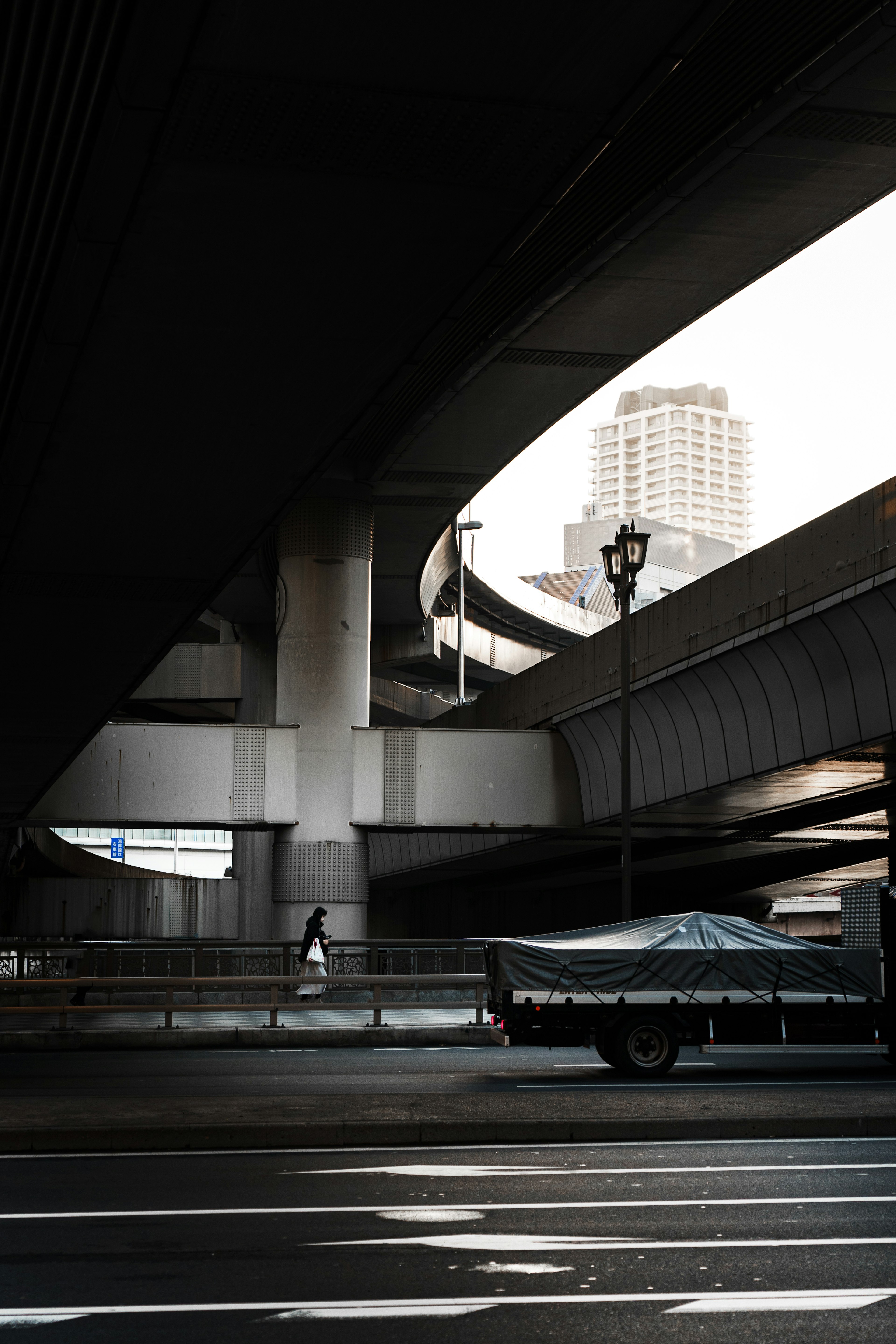 Urban scene featuring intersecting overpasses and a building