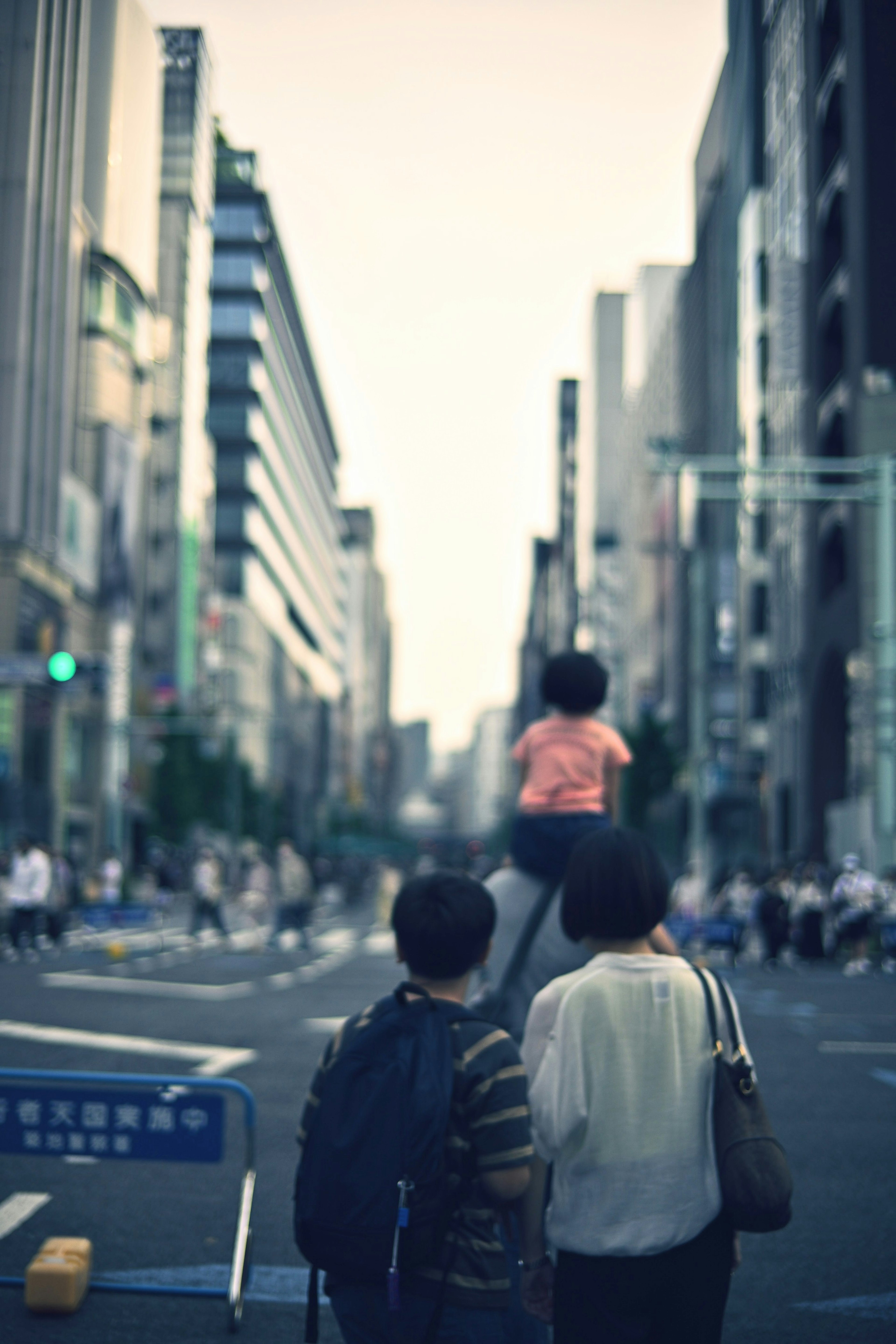 Urban street scene with people walking and buildings