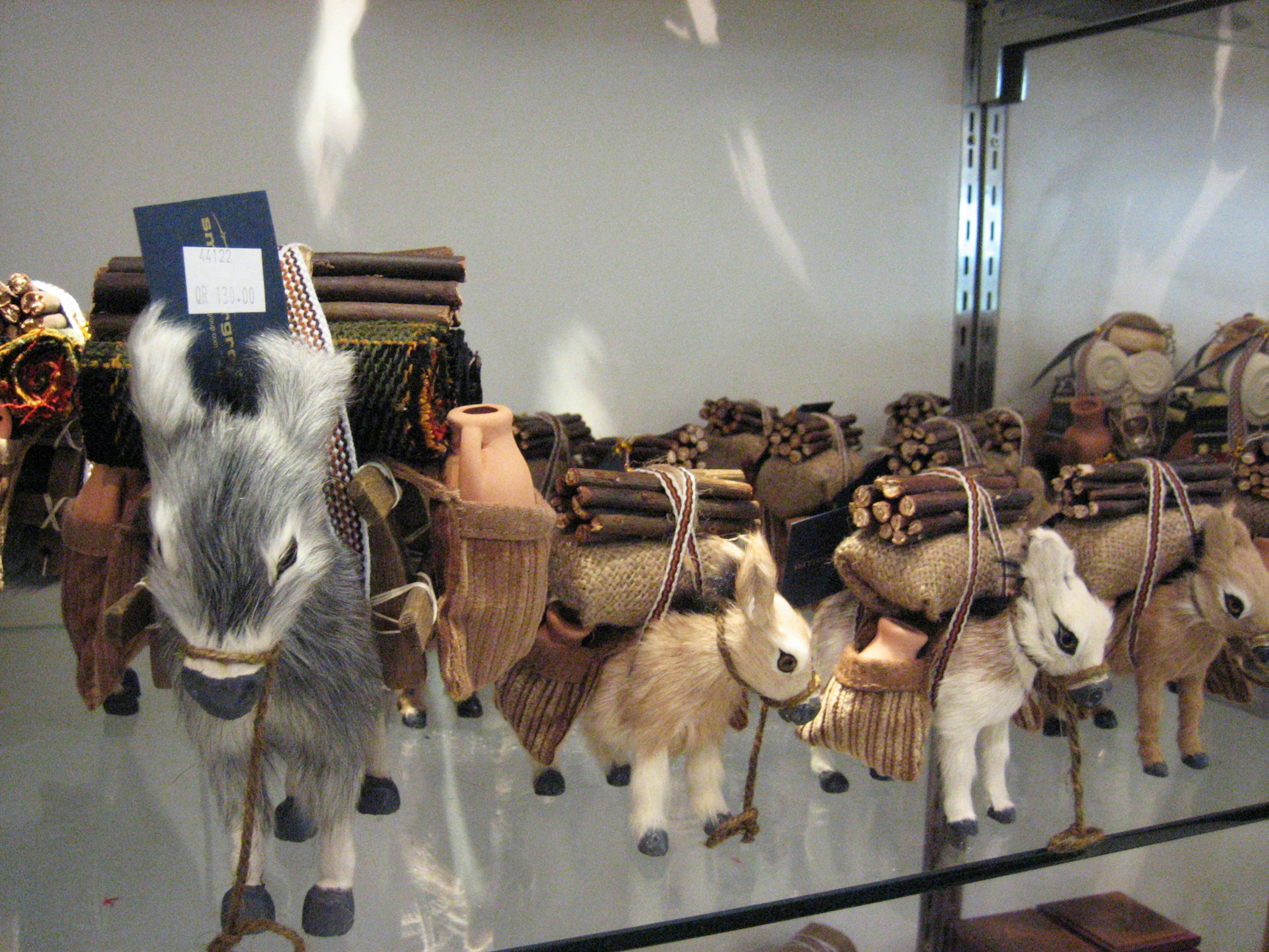 Small figurines of horses carrying bundles on their backs