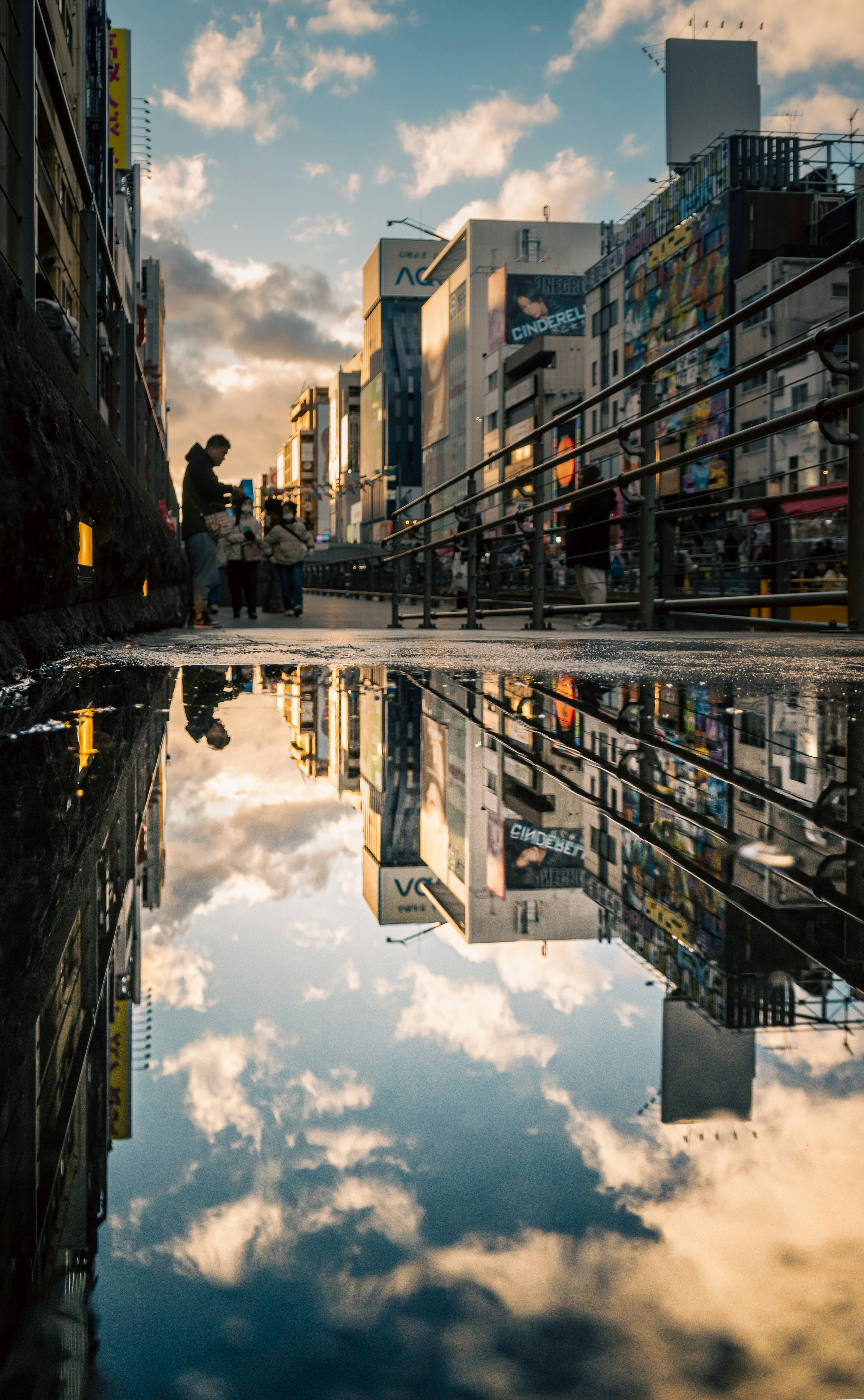 Cityscape at dusk reflected in a puddle