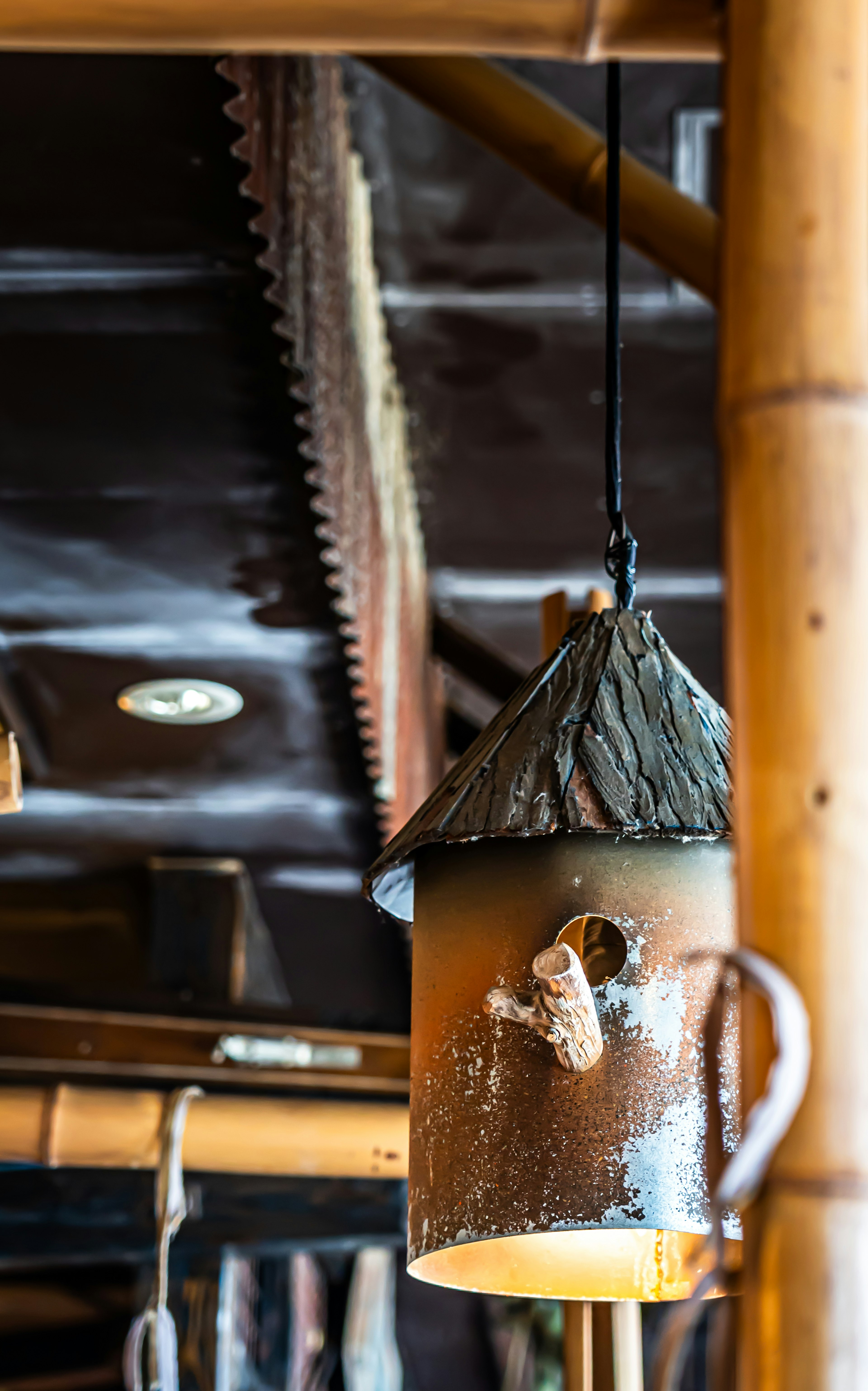 A wooden lamp hanging in a warm interior setting