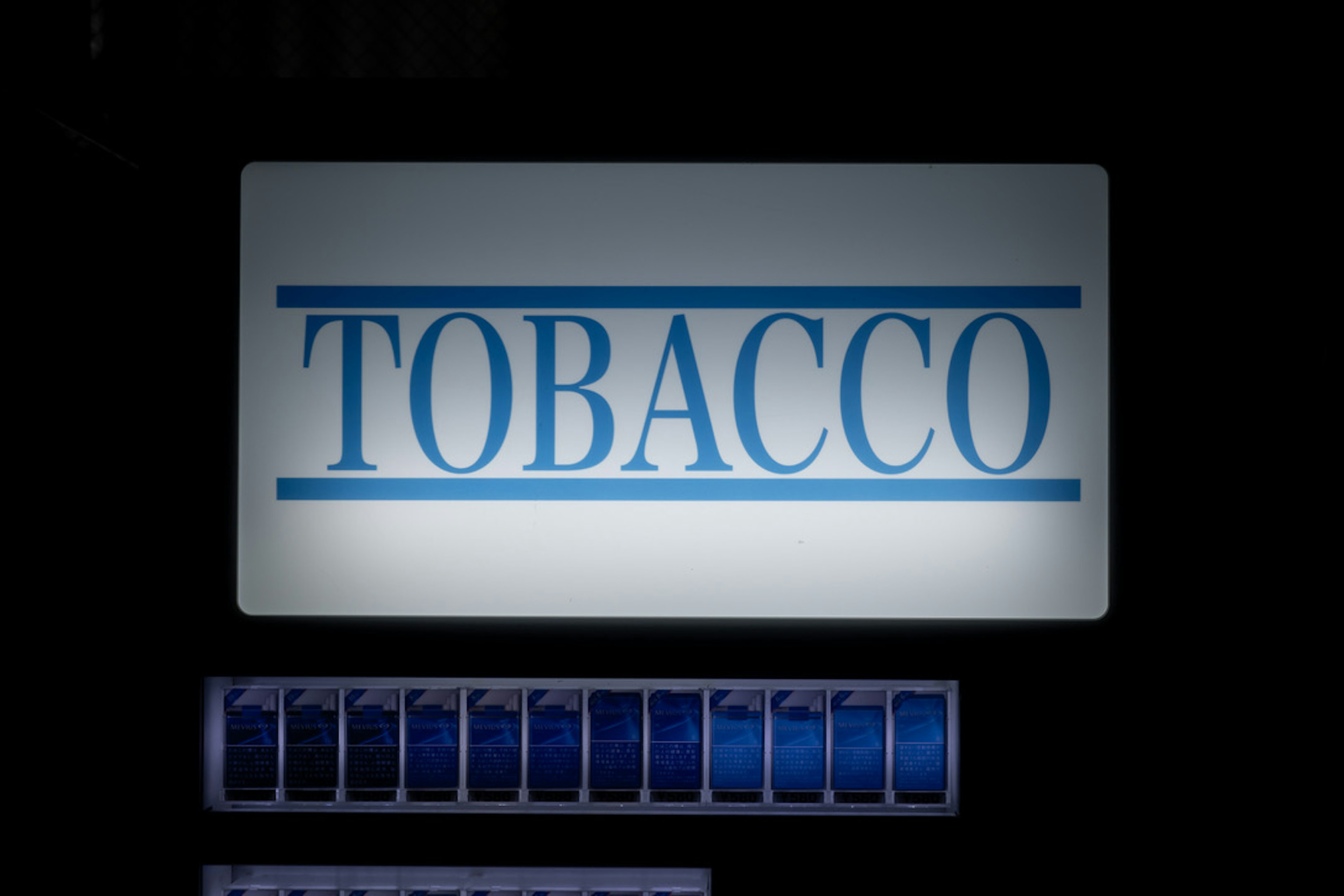 Image of a sign displaying the word TOBACCO in blue letters