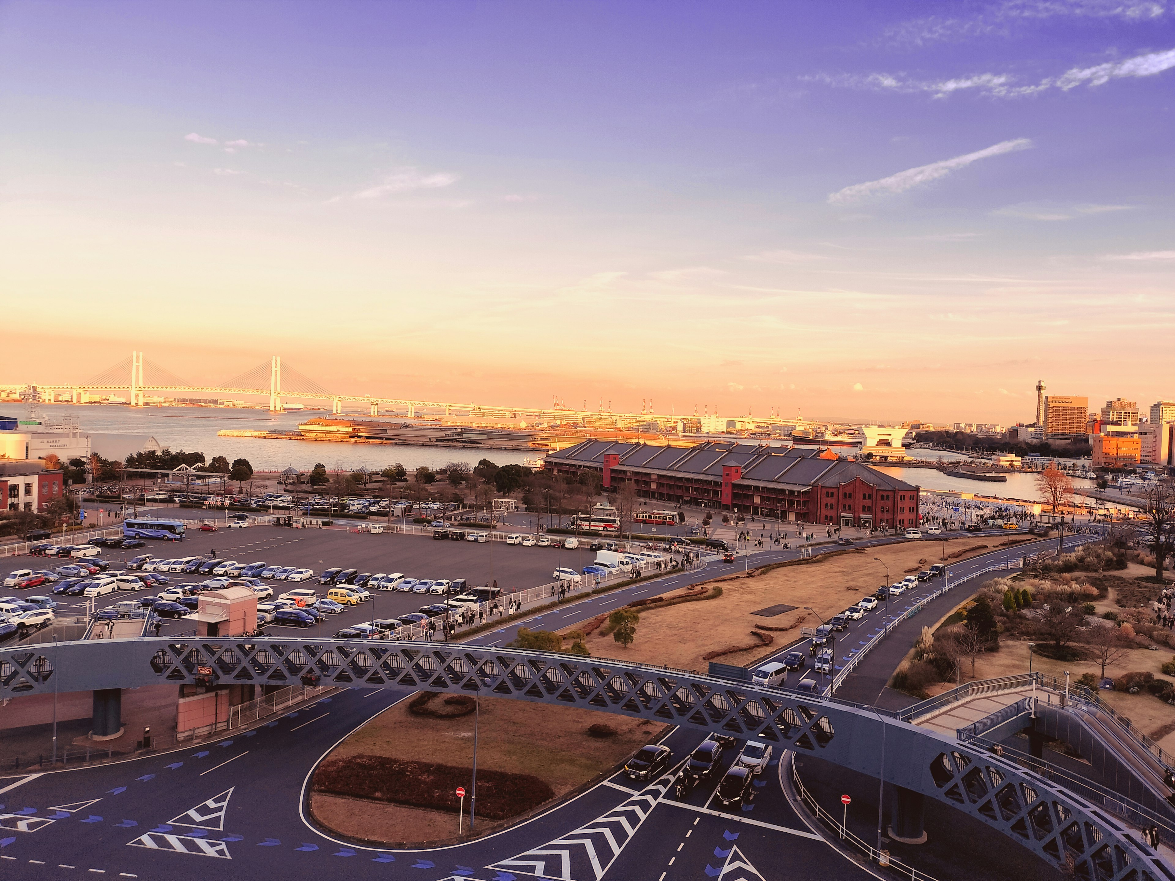 Sunset view of a harbor with a winding road