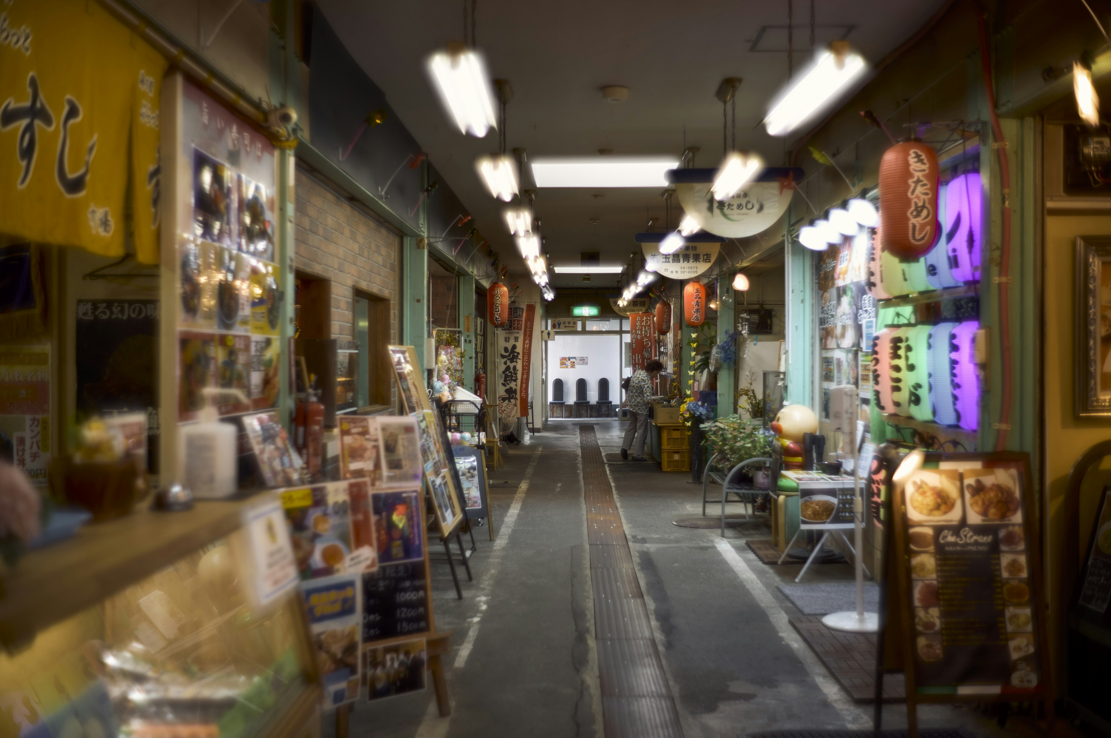 A lively shopping street with shops and colorful signs