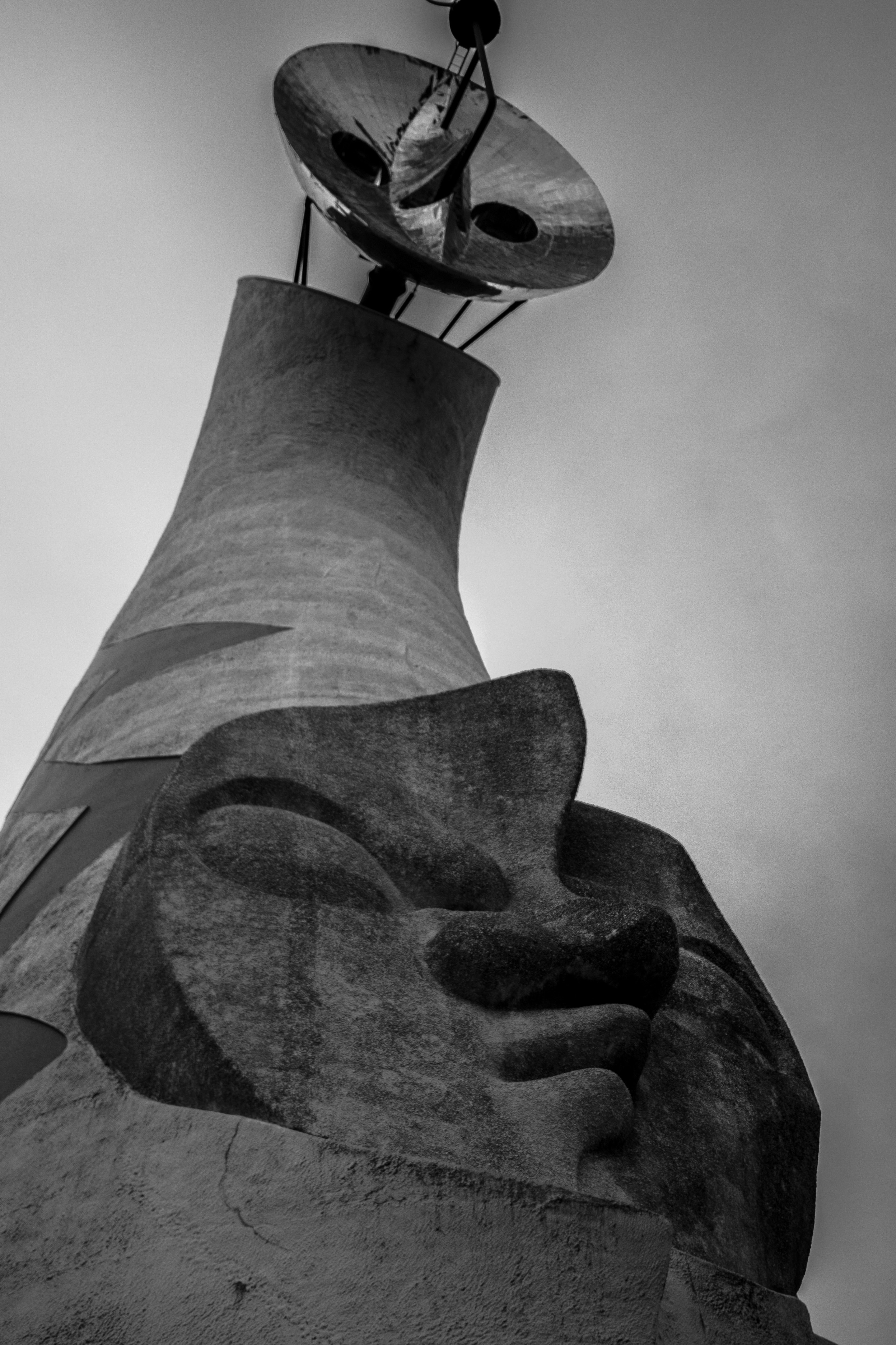 Black and white sculpture tower with face motif design