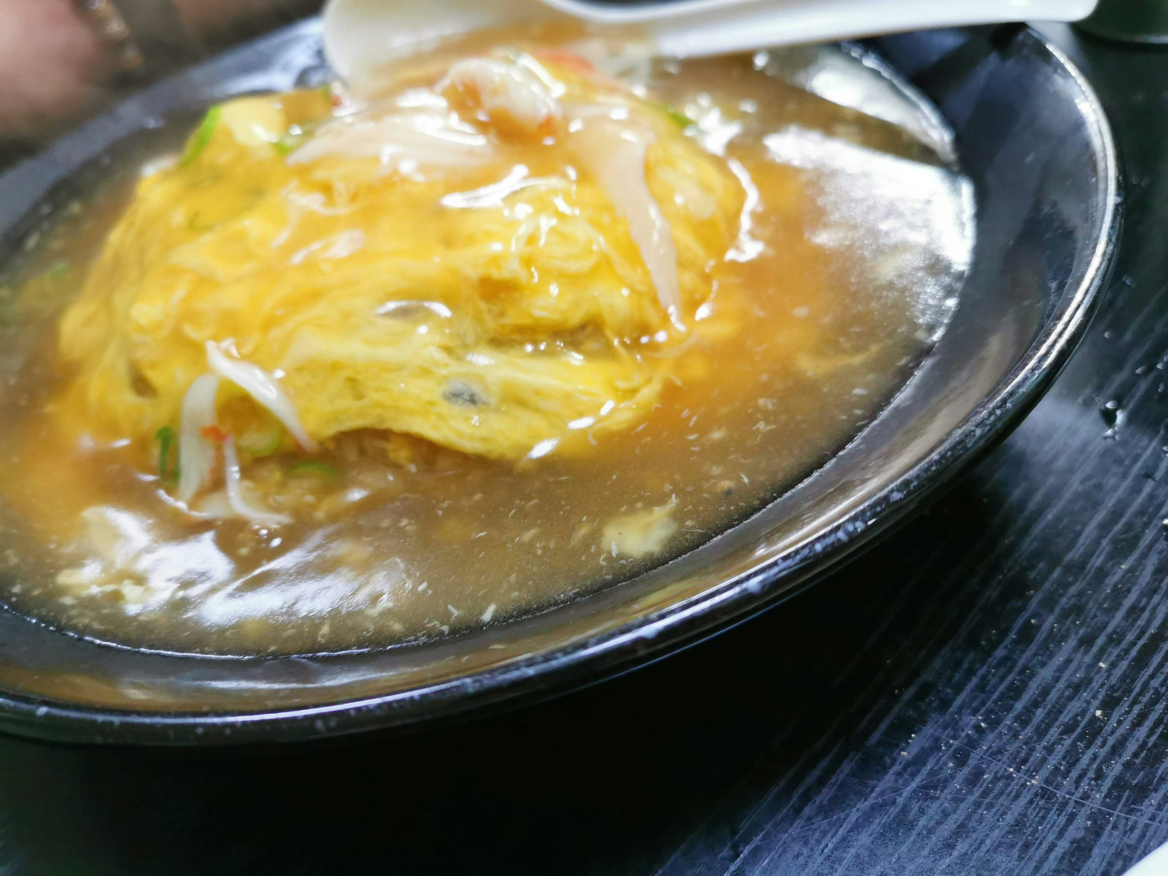 A dish of omelette served in a savory broth