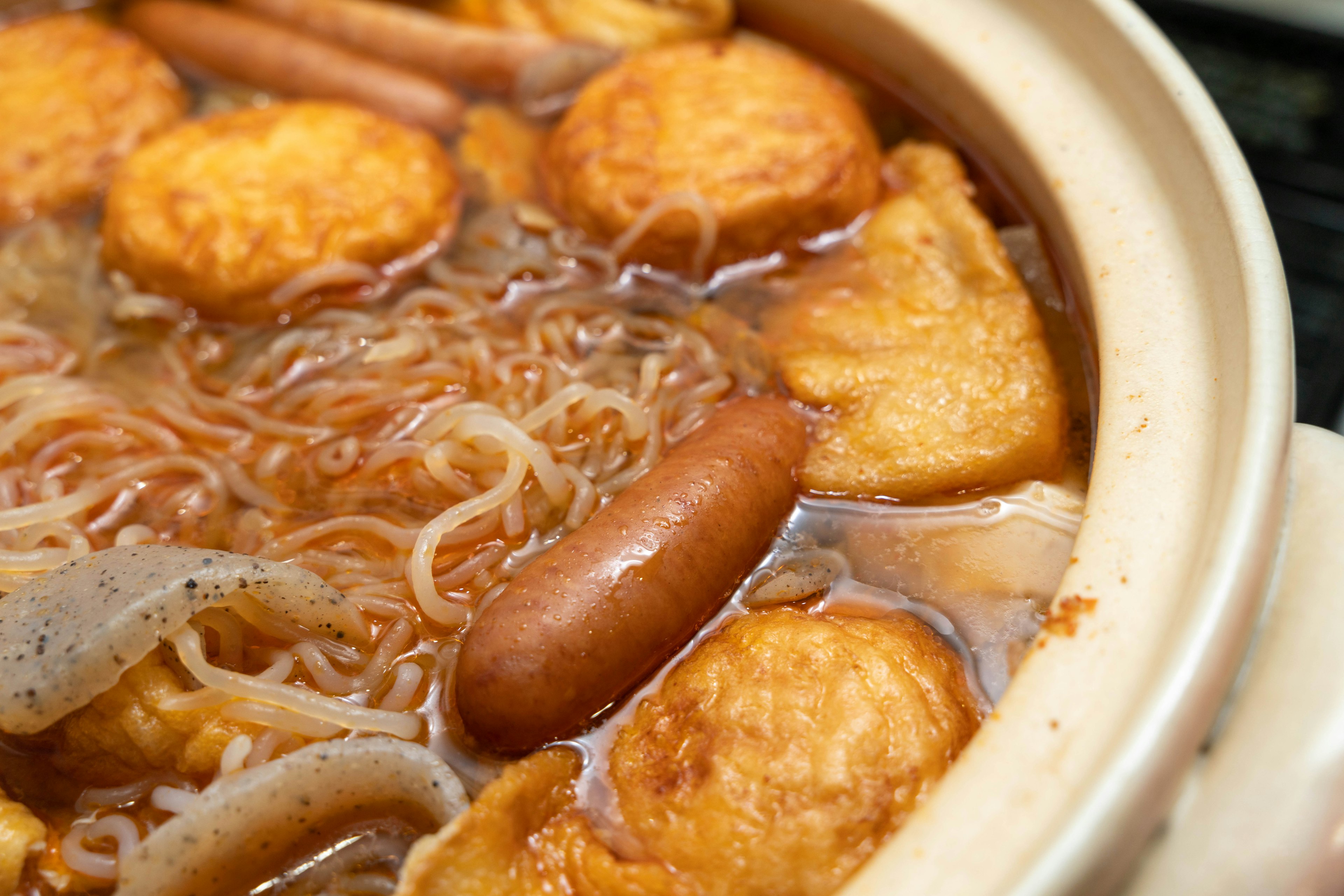 Noodle dish with various ingredients in a pot