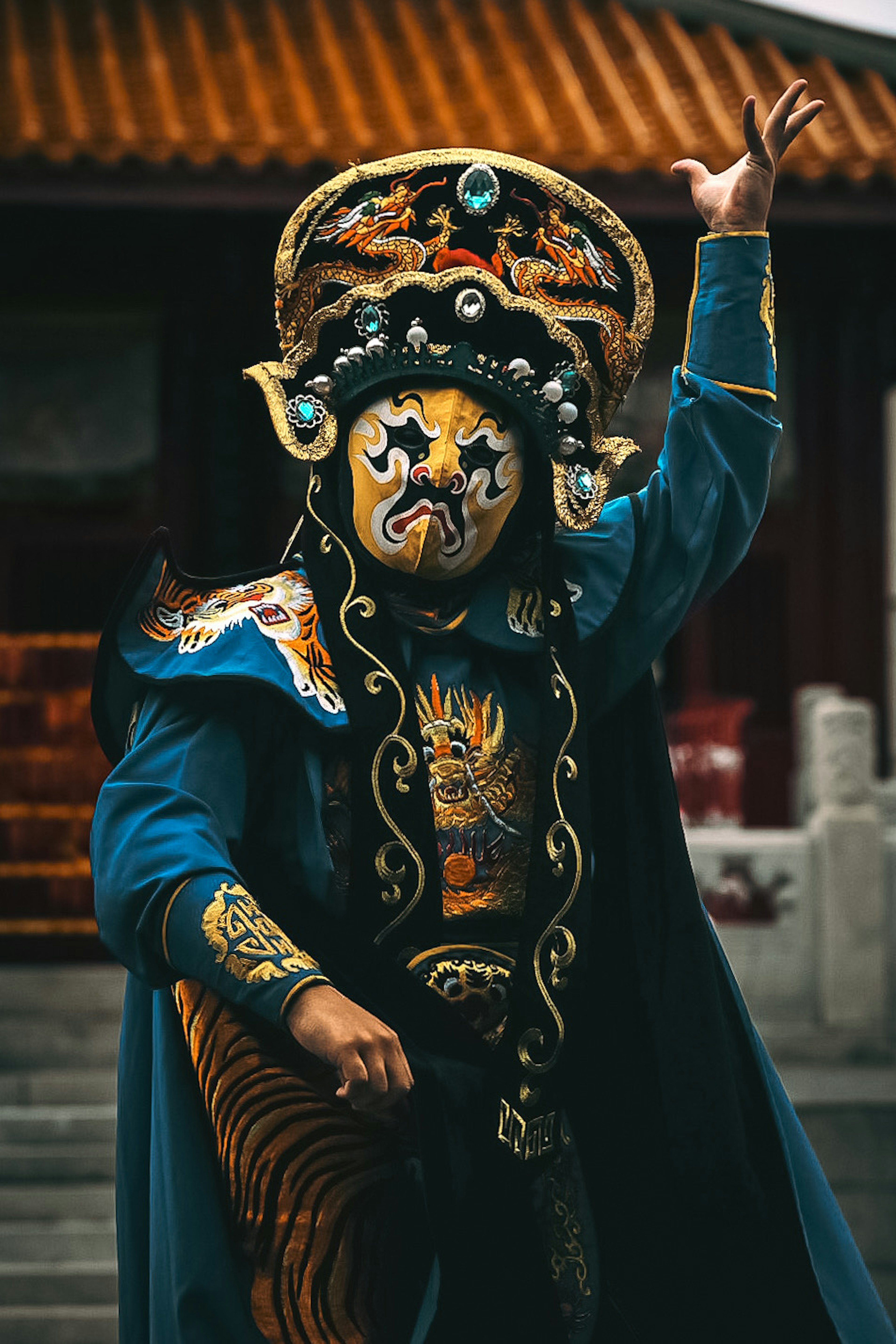 Performer in traditional costume striking a pose on stage