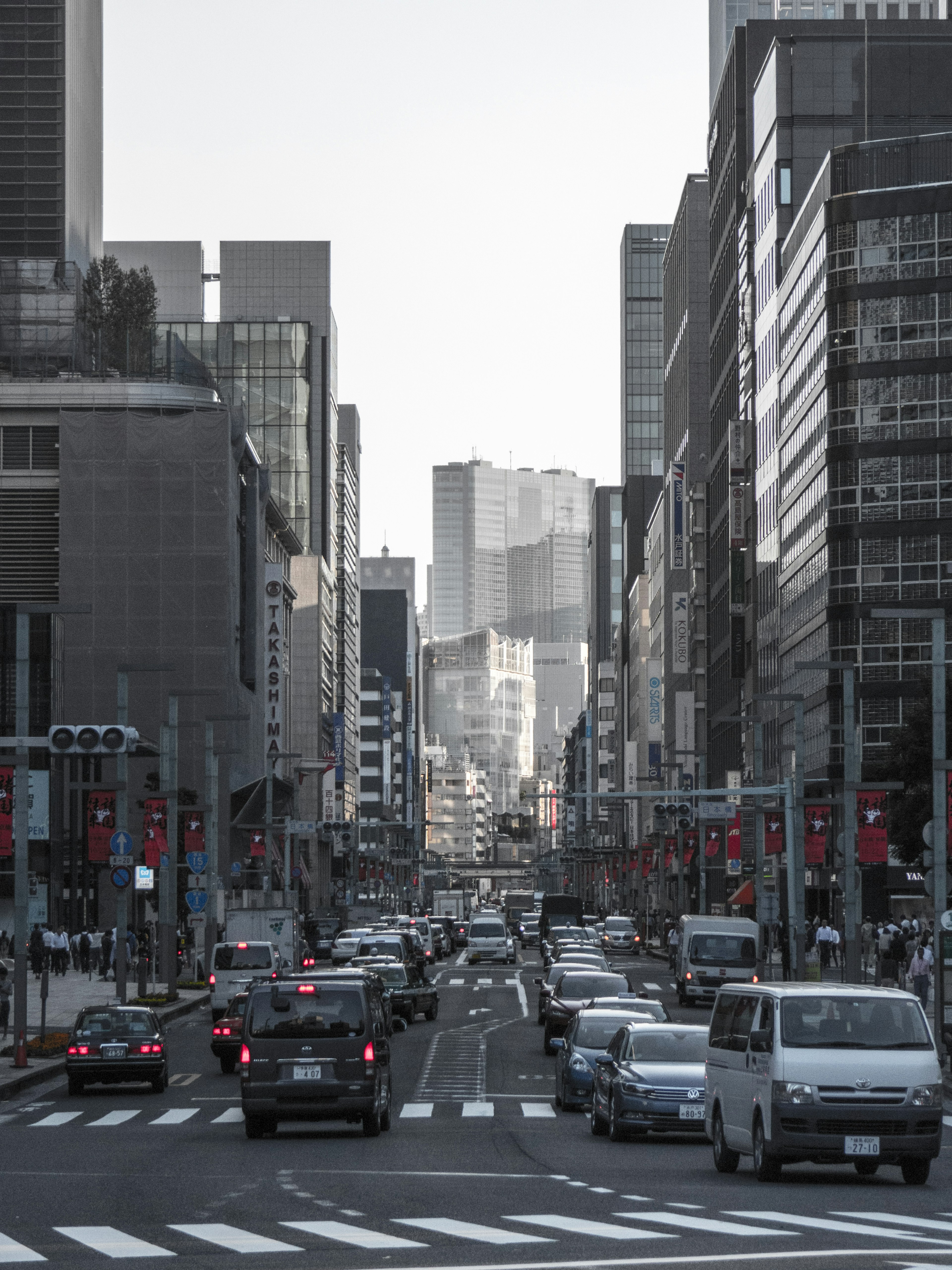 City street scene with cars and tall buildings