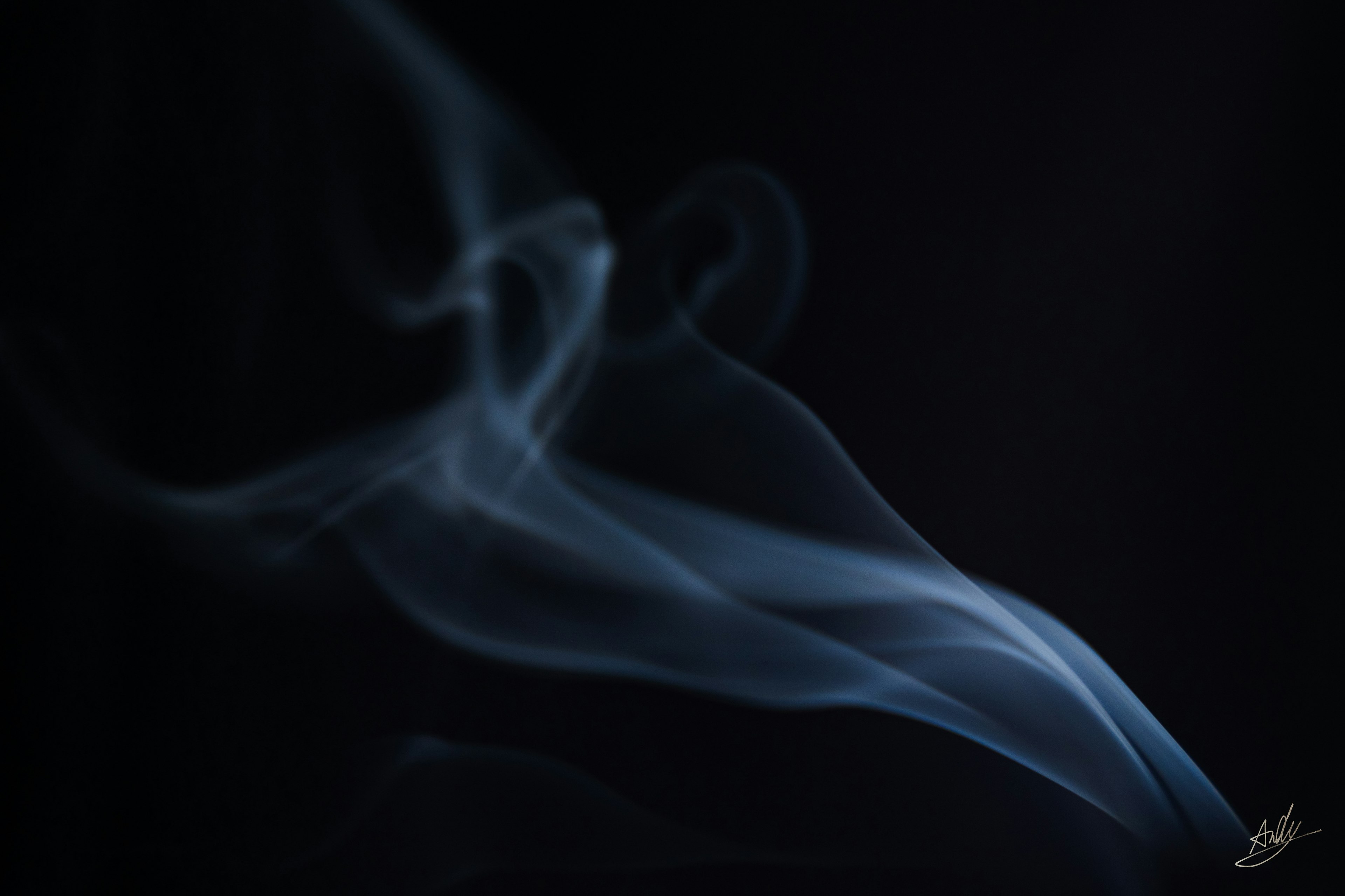 Flowing blue smoke against a black background