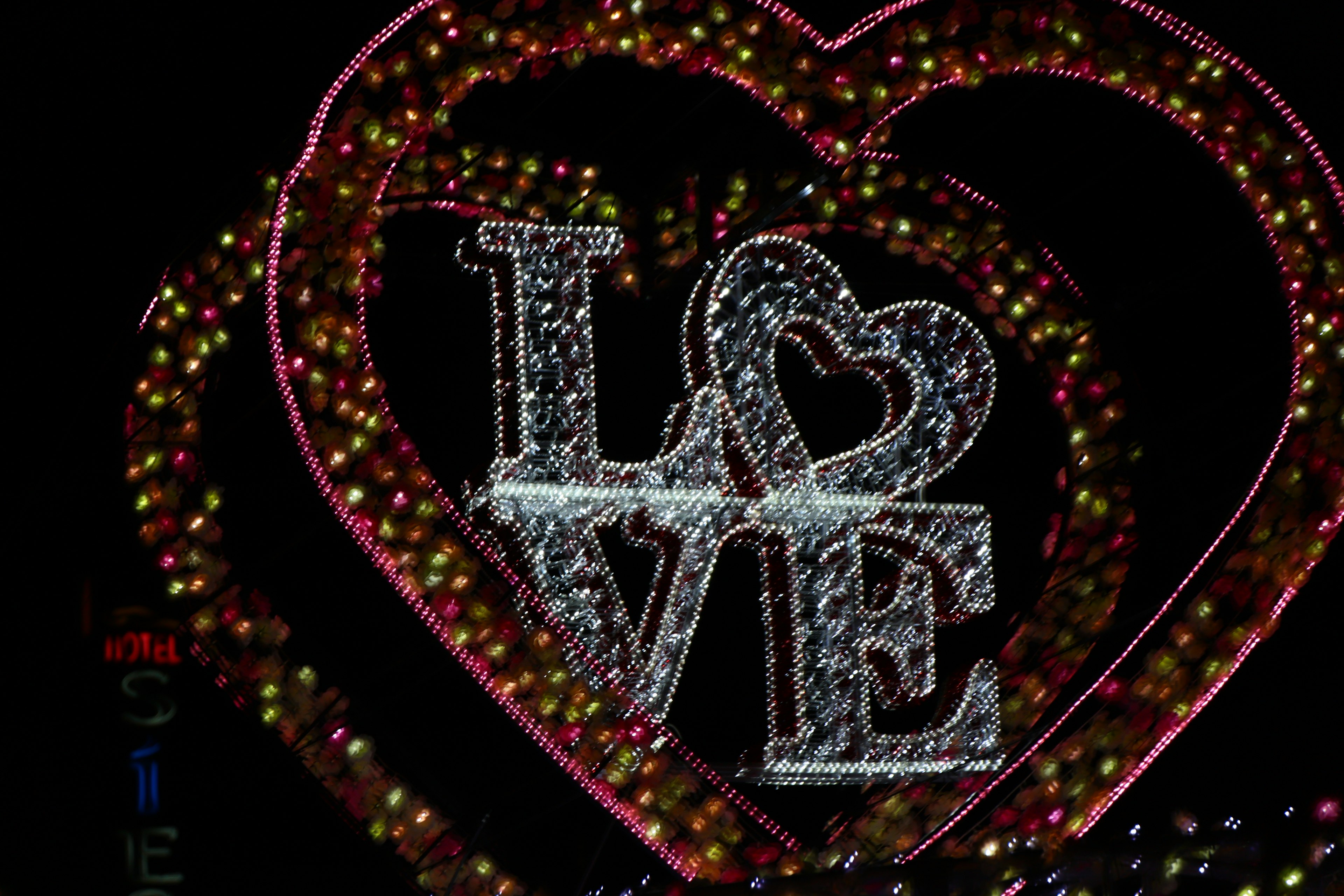 A large heart decorated with colorful lights featuring the word LOVE