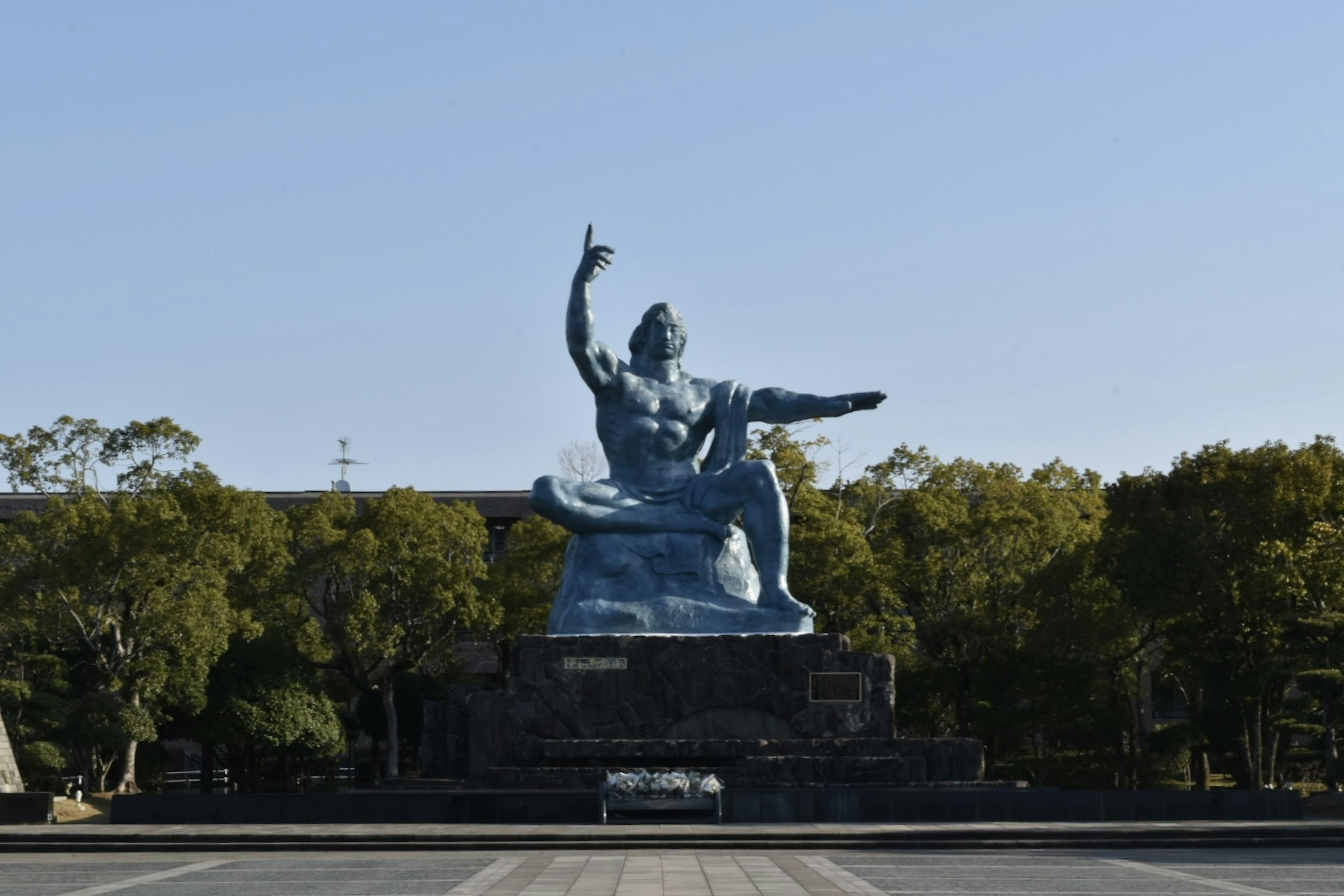 Large blue statue seated in a plaza