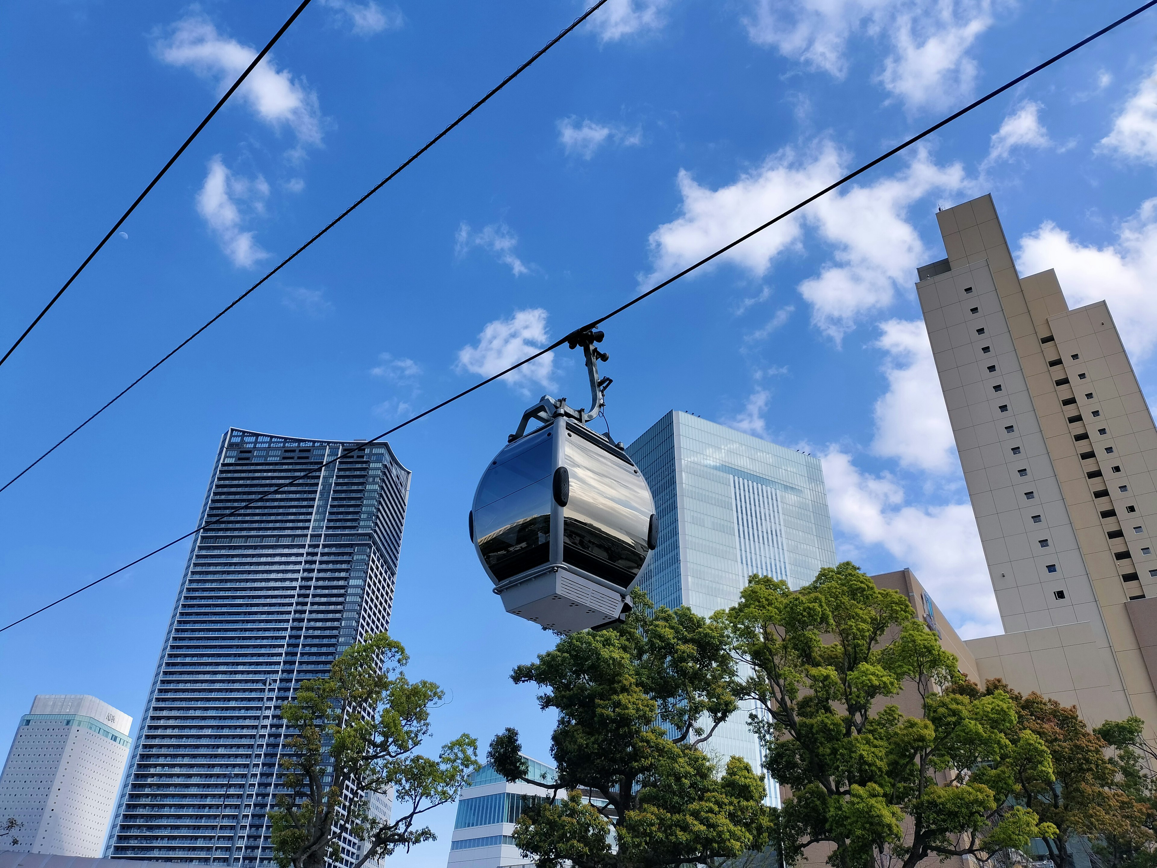 A cable car gliding through the city skyline with skyscrapers