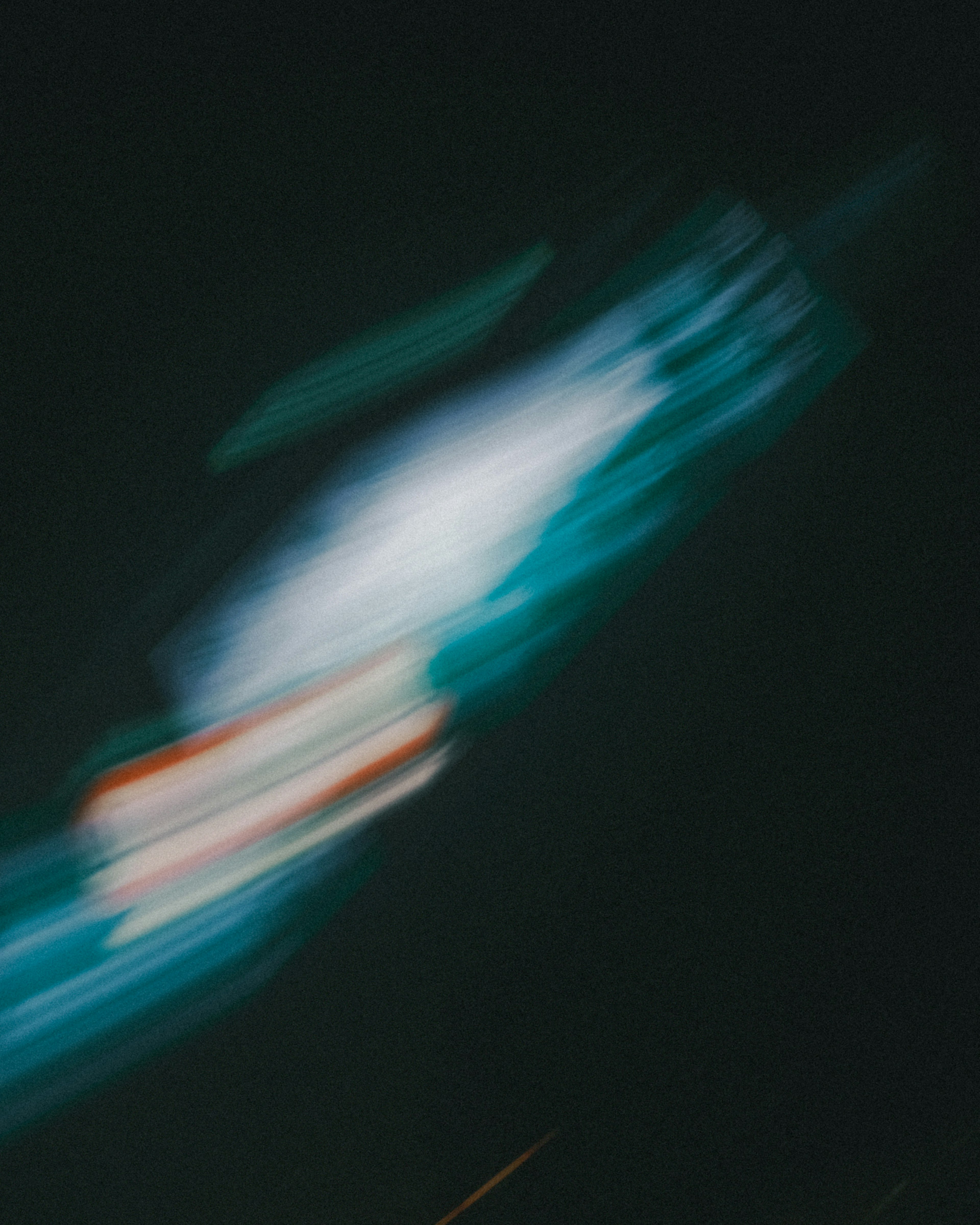 Abstract image of flowing light trails against a dark background