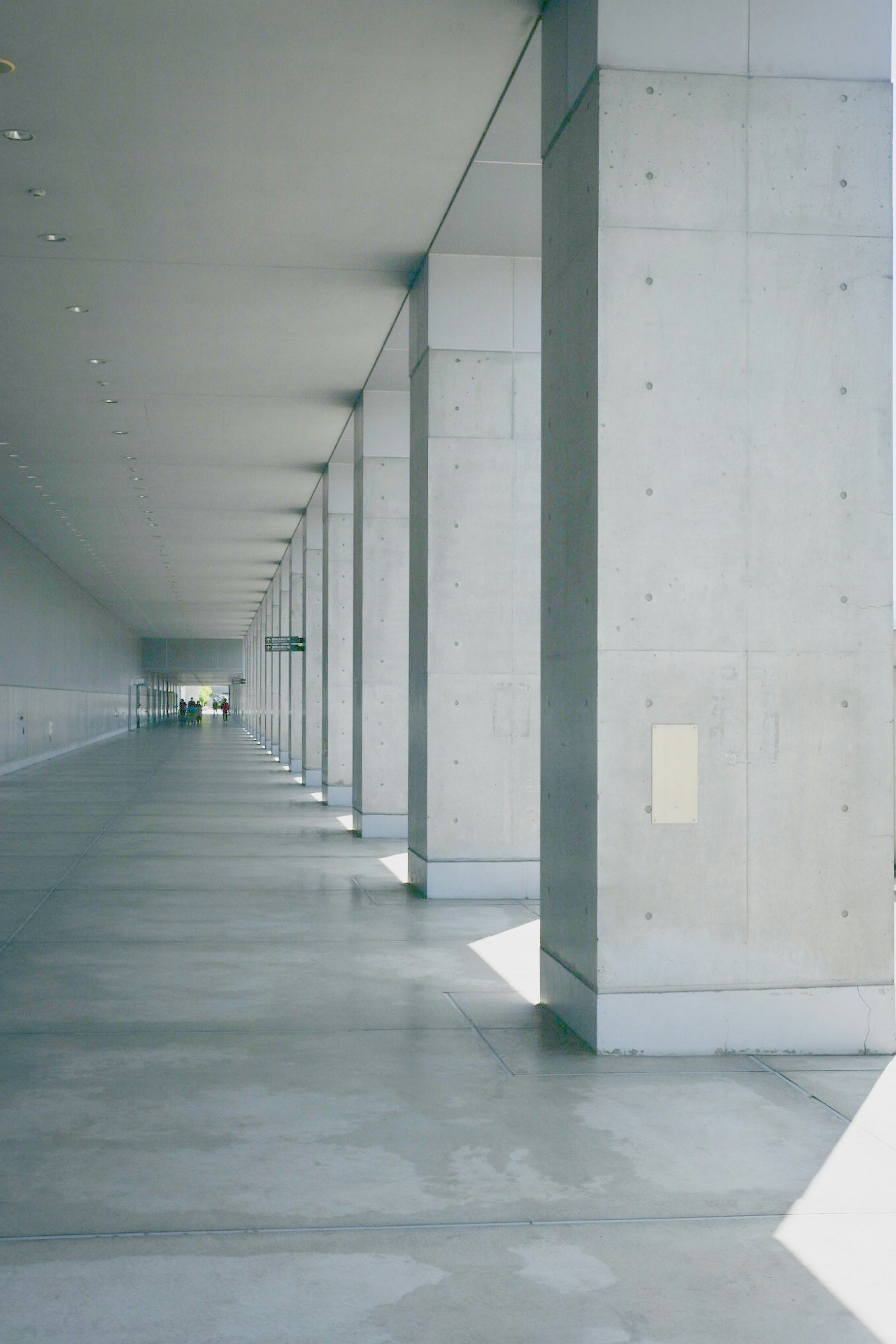 Spacious interior corridor lined with concrete pillars