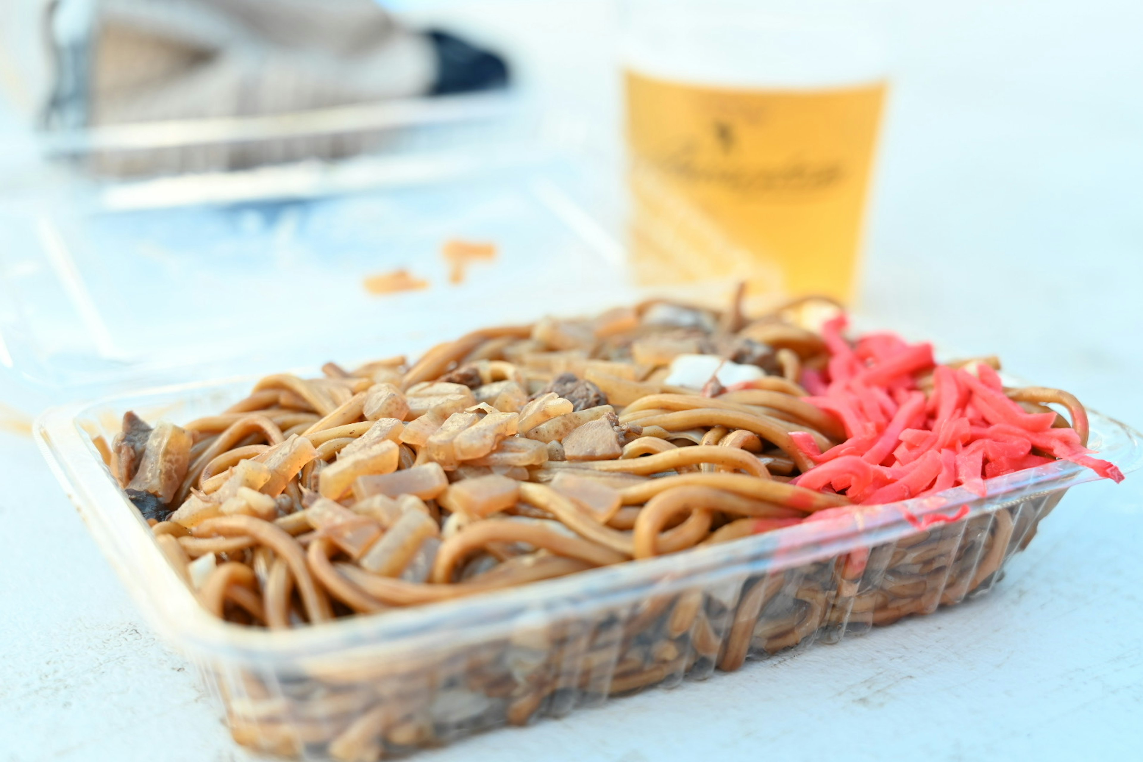 Takeout container of yakisoba with pickled ginger