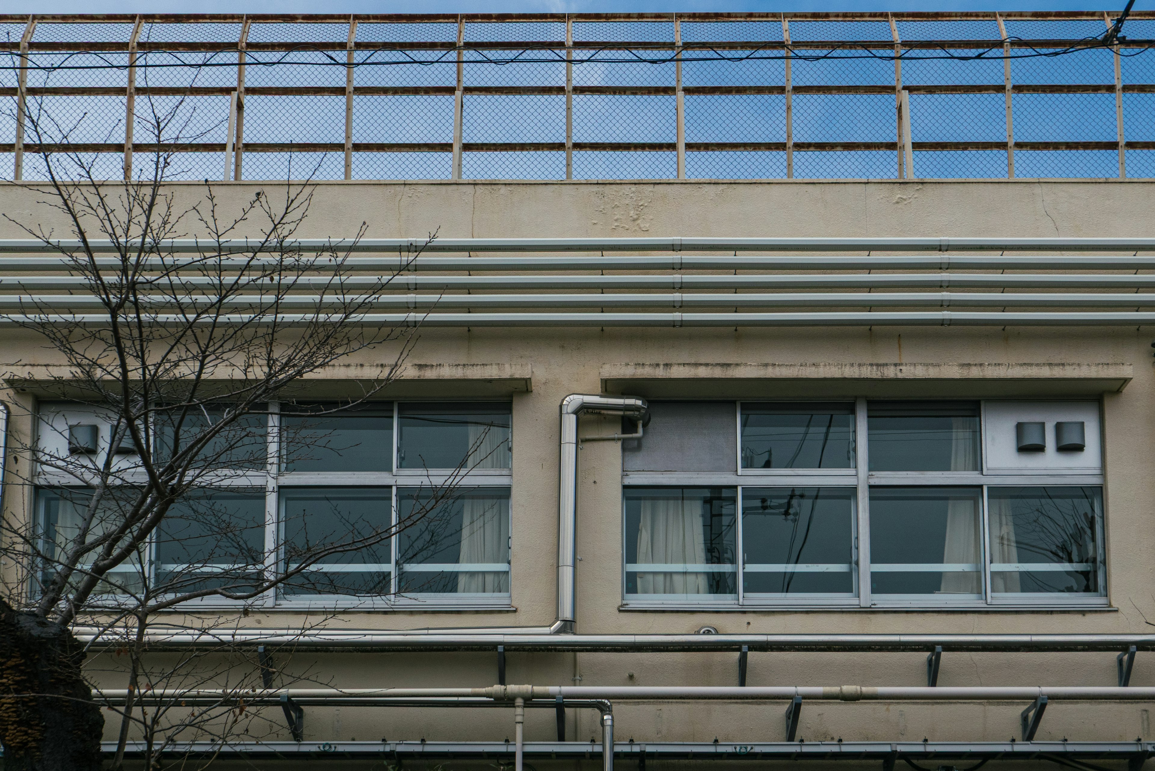 Facade of a building featuring large windows and a blue sky