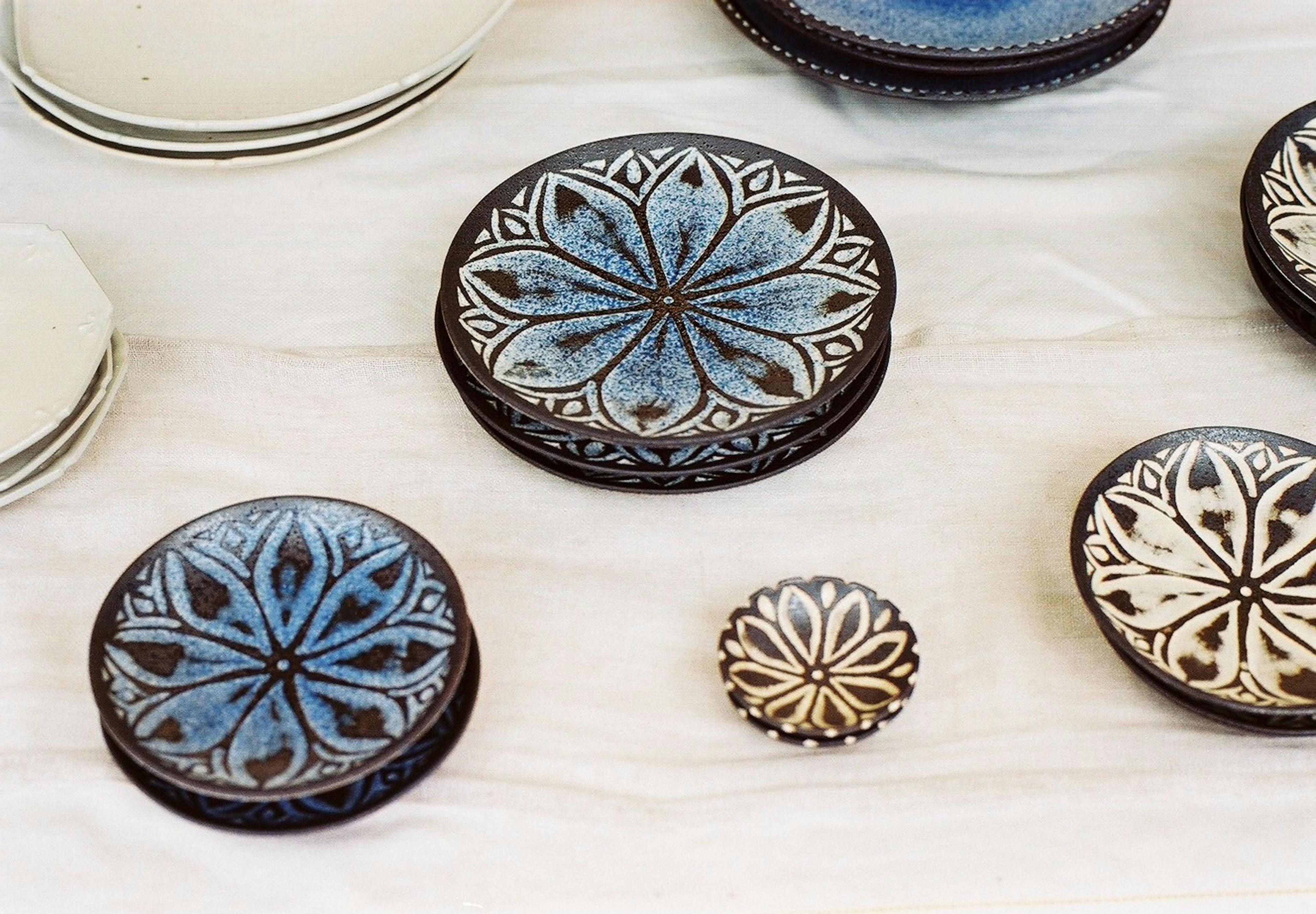 Ceramic plates with blue and white floral designs arranged on a surface