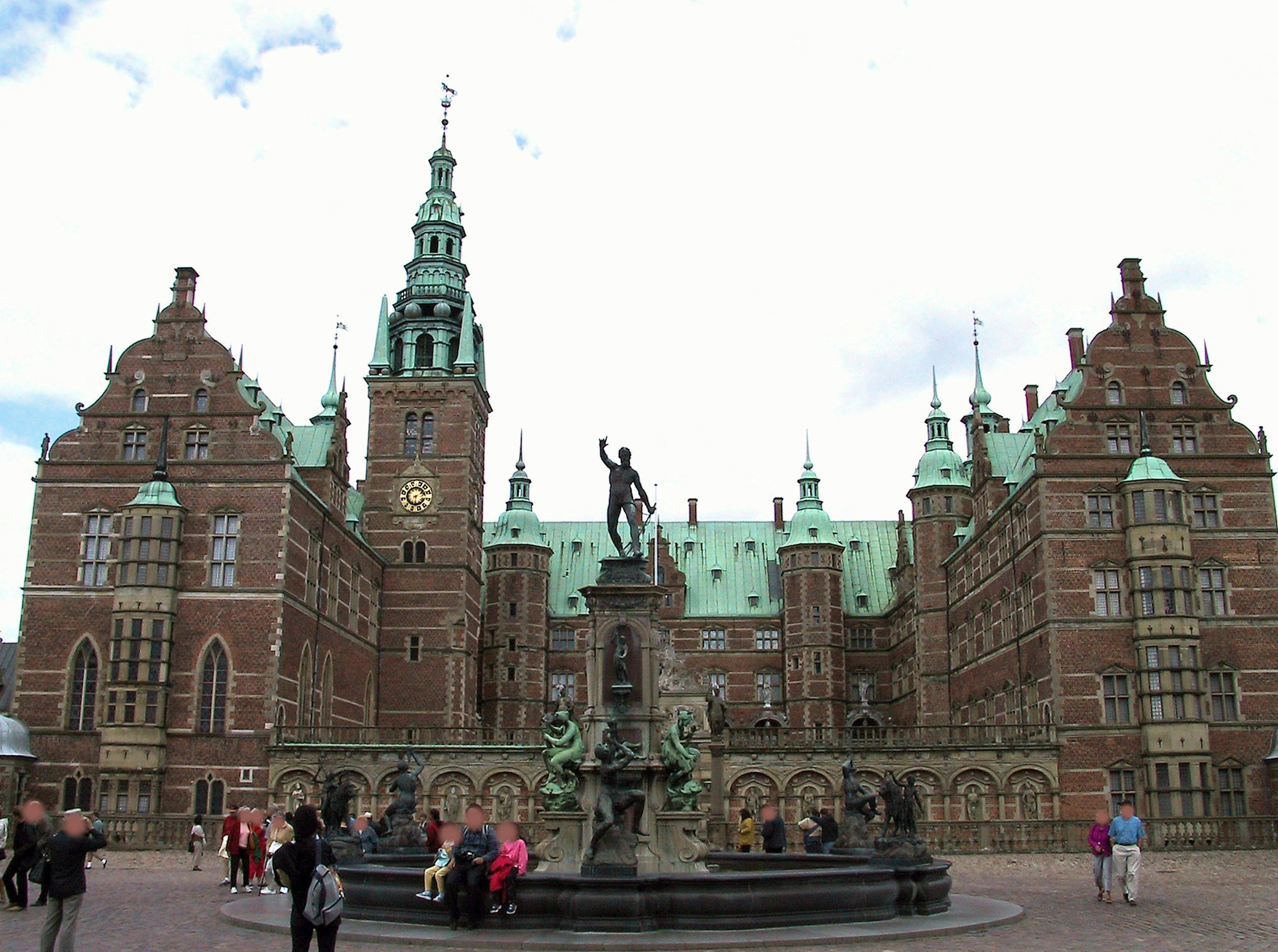 Imposing castle facade with green roofs and intricate architecture