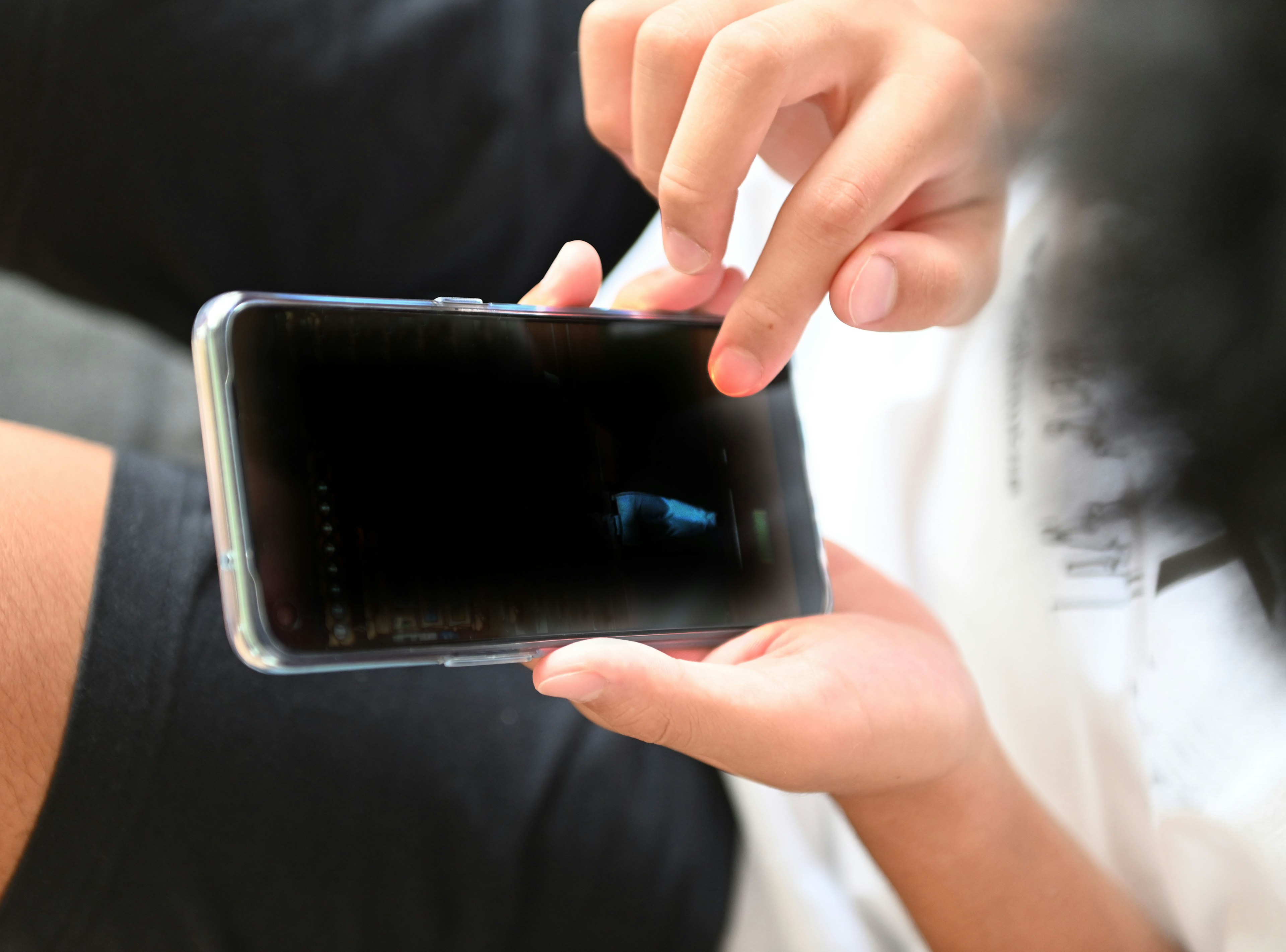 Child's hands interacting with a smartphone