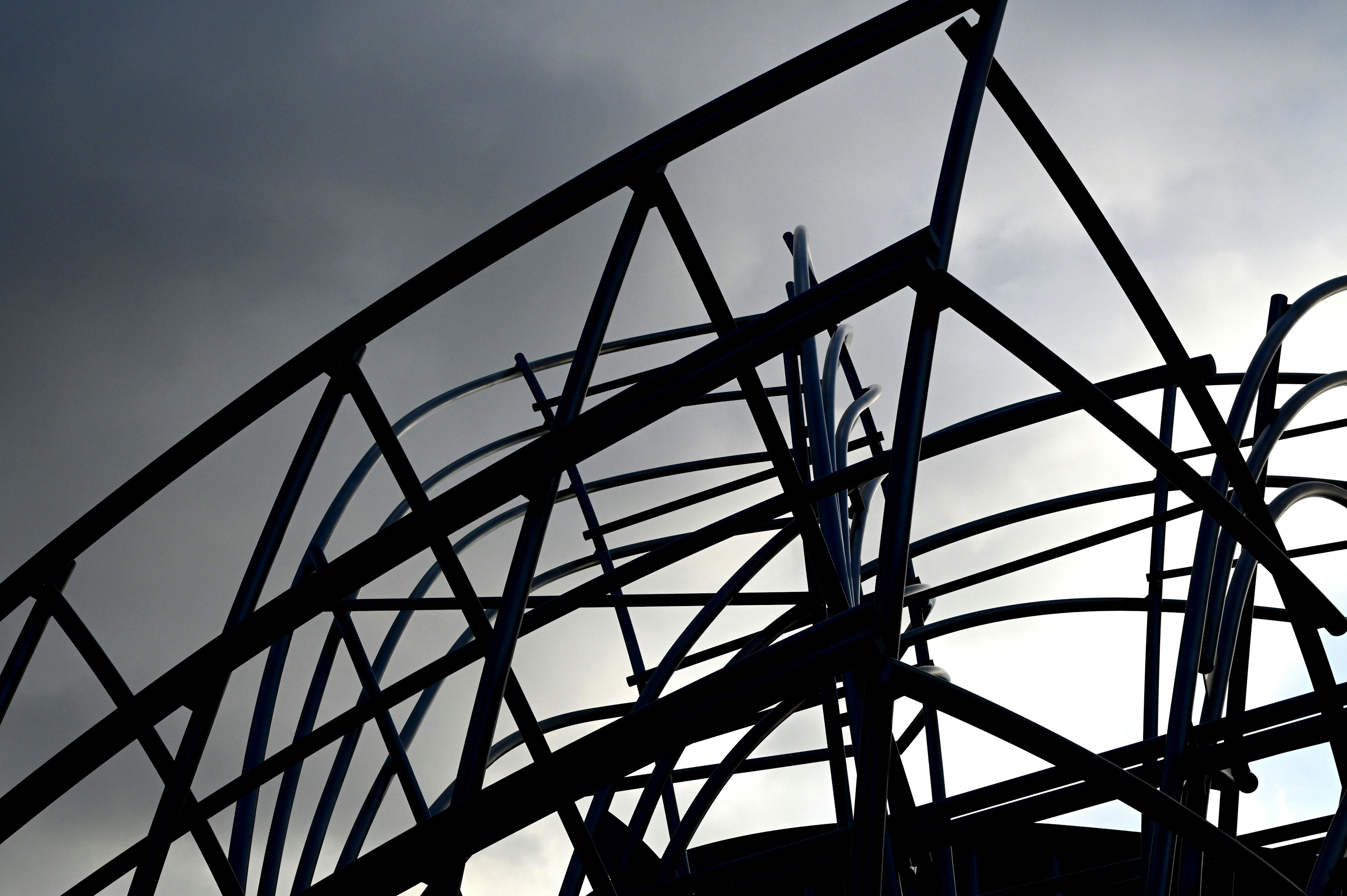 Silhouette of a steel structure under a dark sky