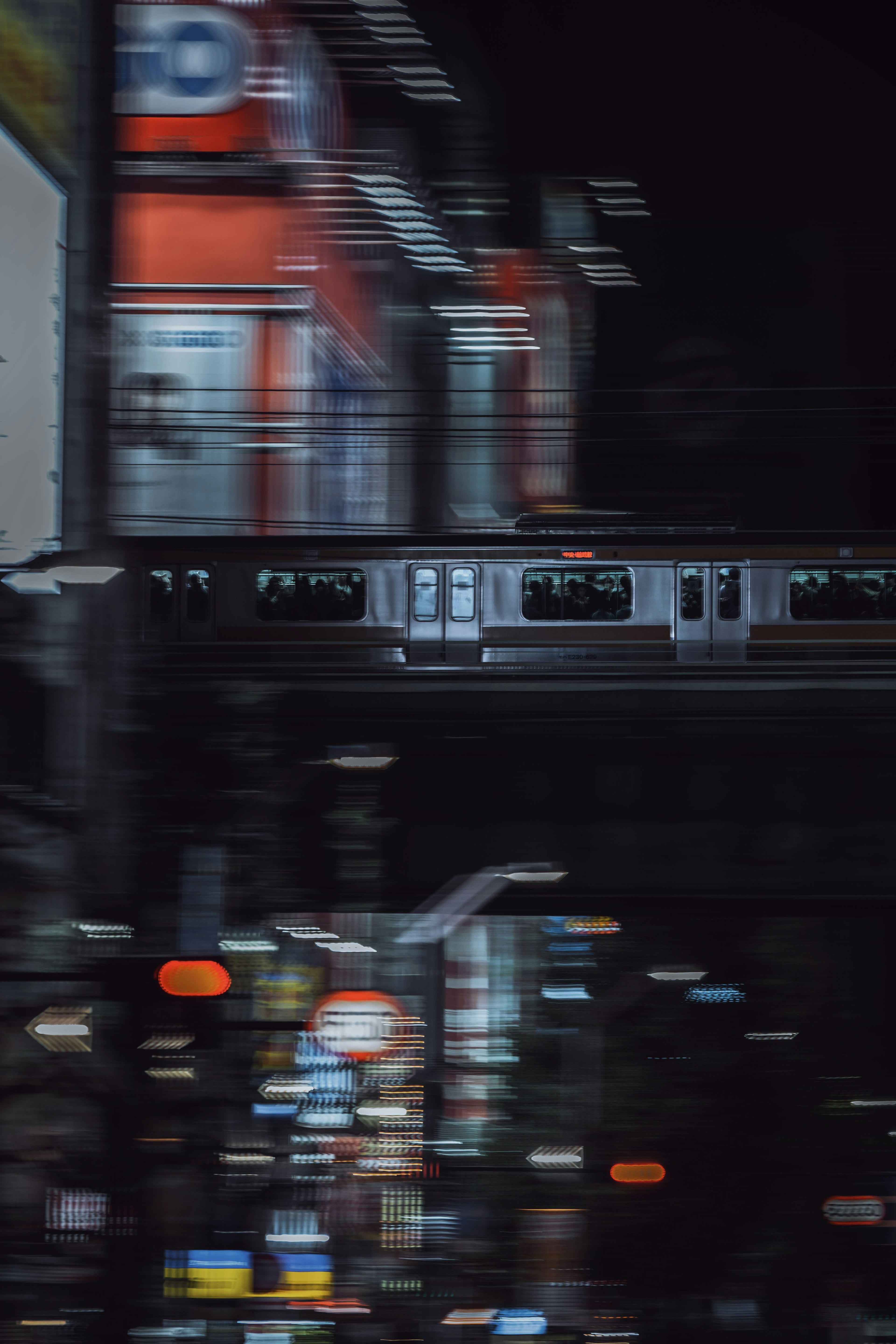 Monorail gliding through a vibrant cityscape at night with neon lights