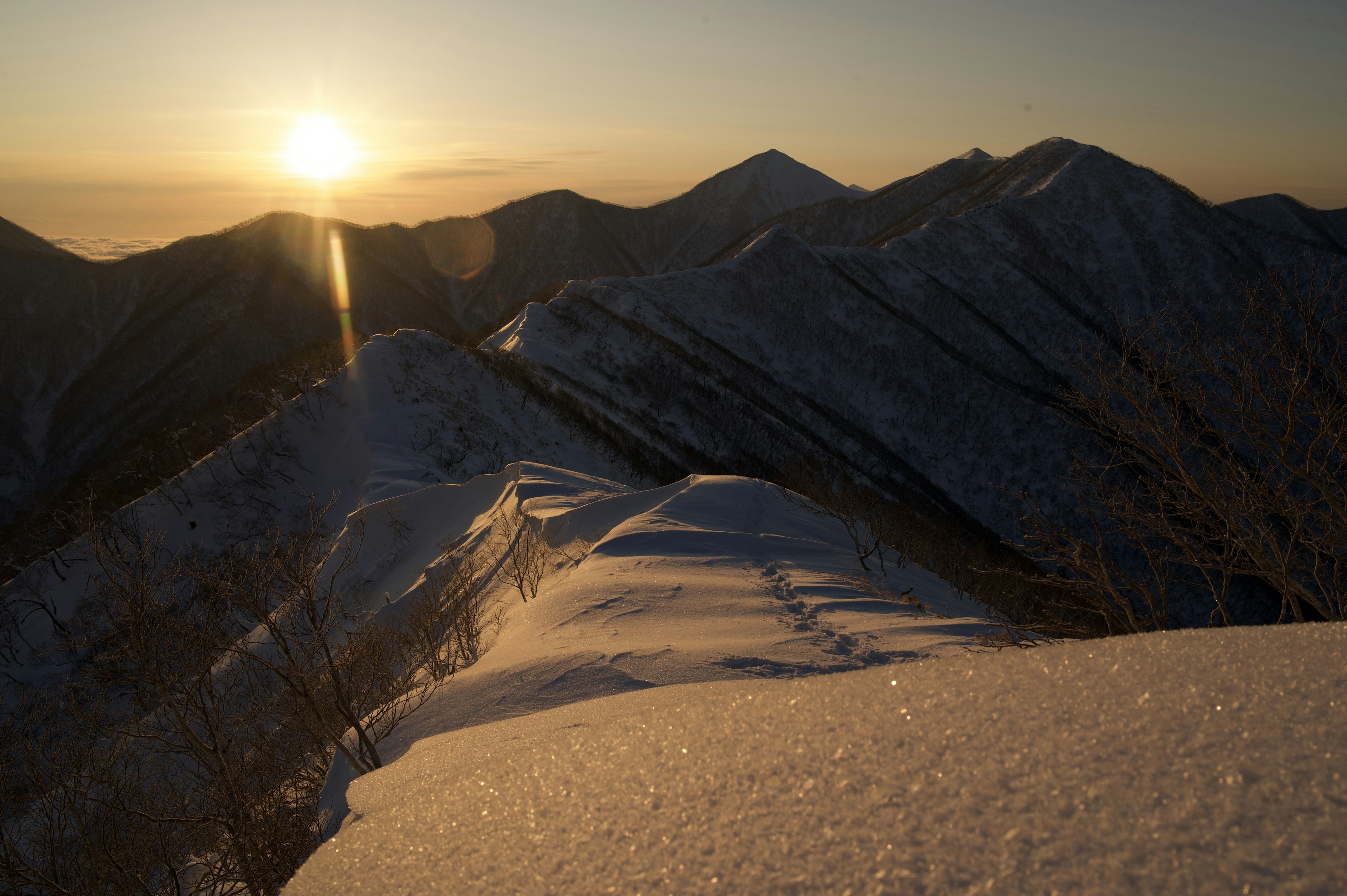 Snow-covered mountains with a sunrise view