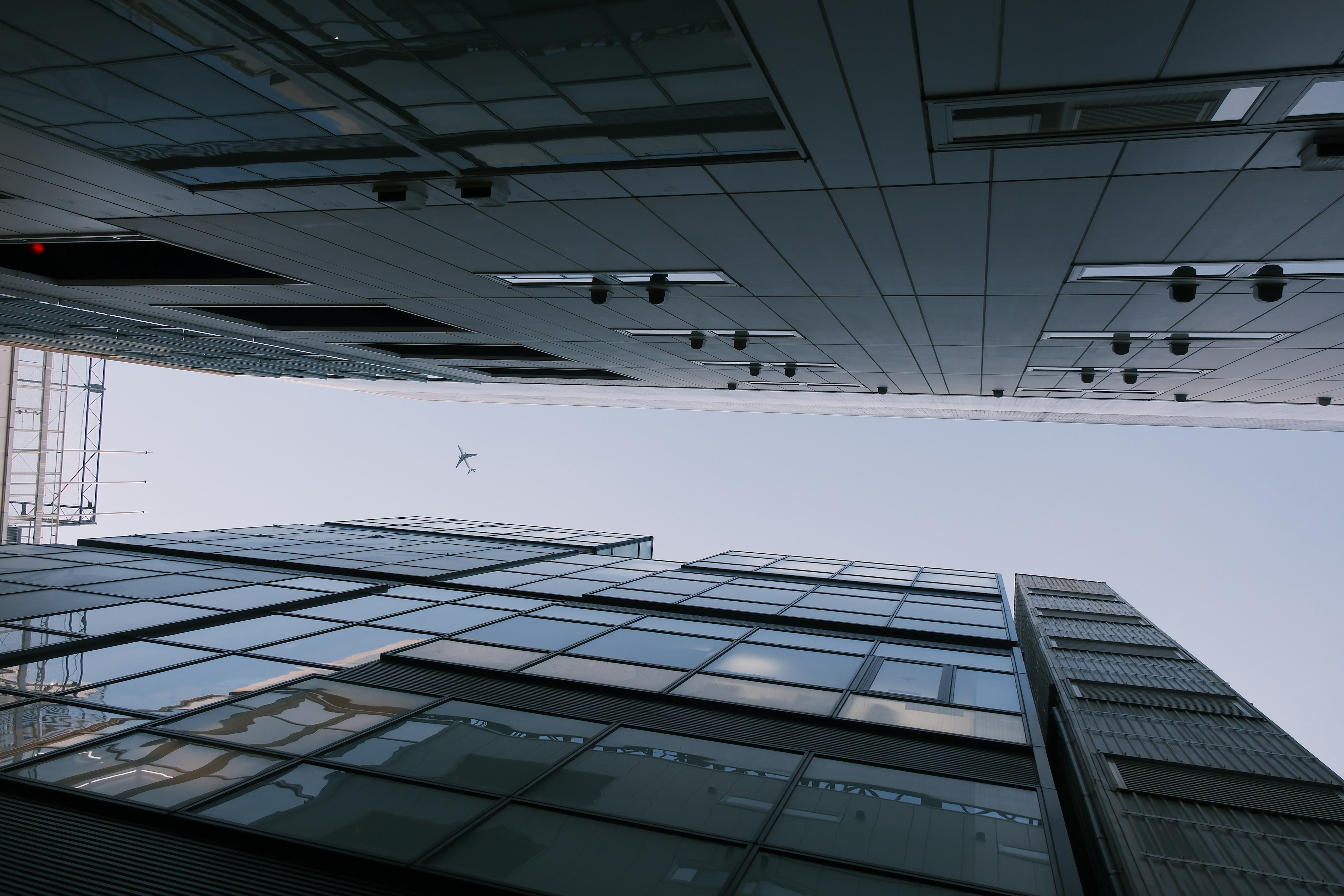 Skyscraper glass facade reaching towards the blue sky