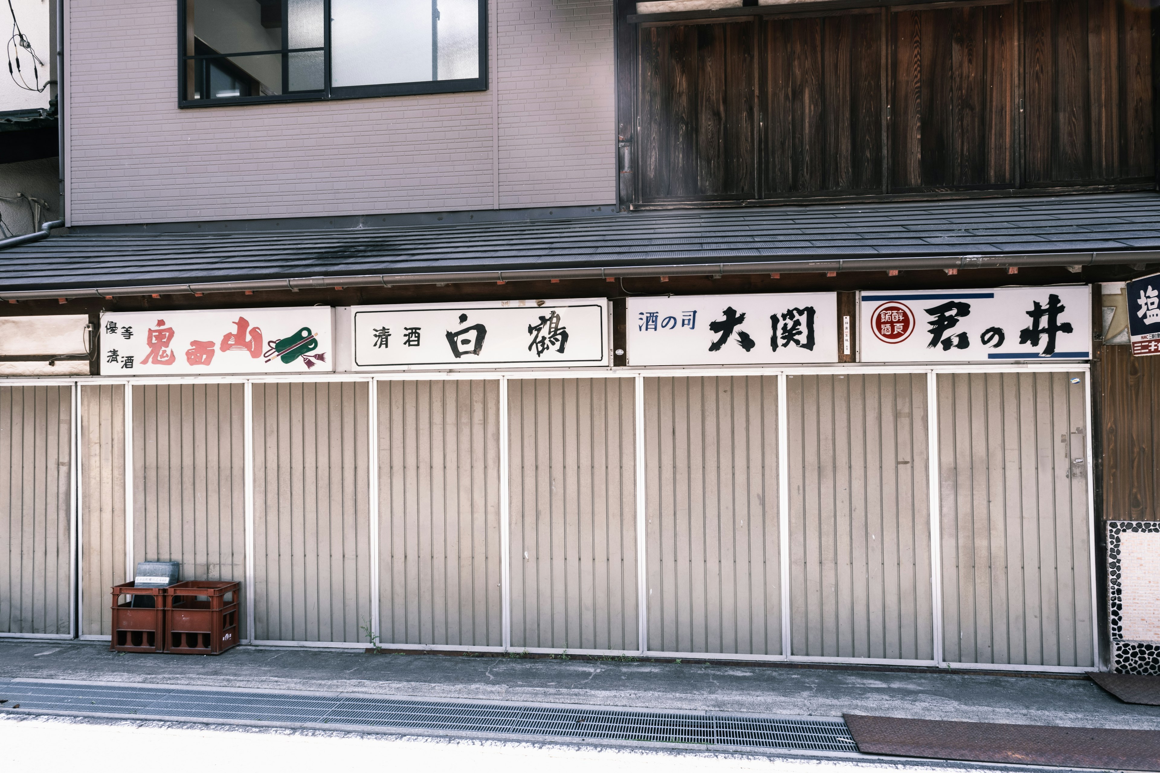 Exterior of closed shops featuring Japanese signs