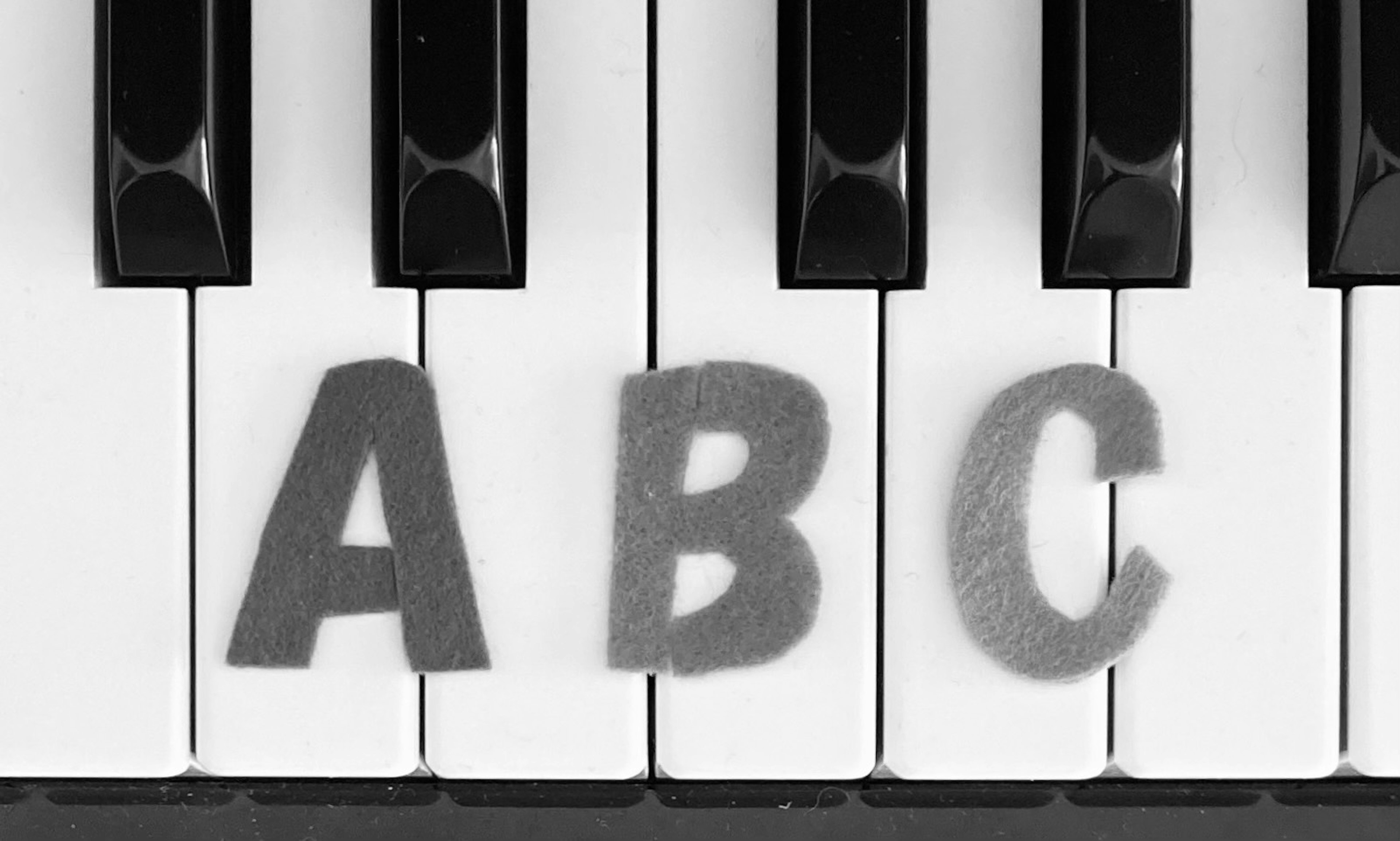 Alphabet letters A B C on piano keys