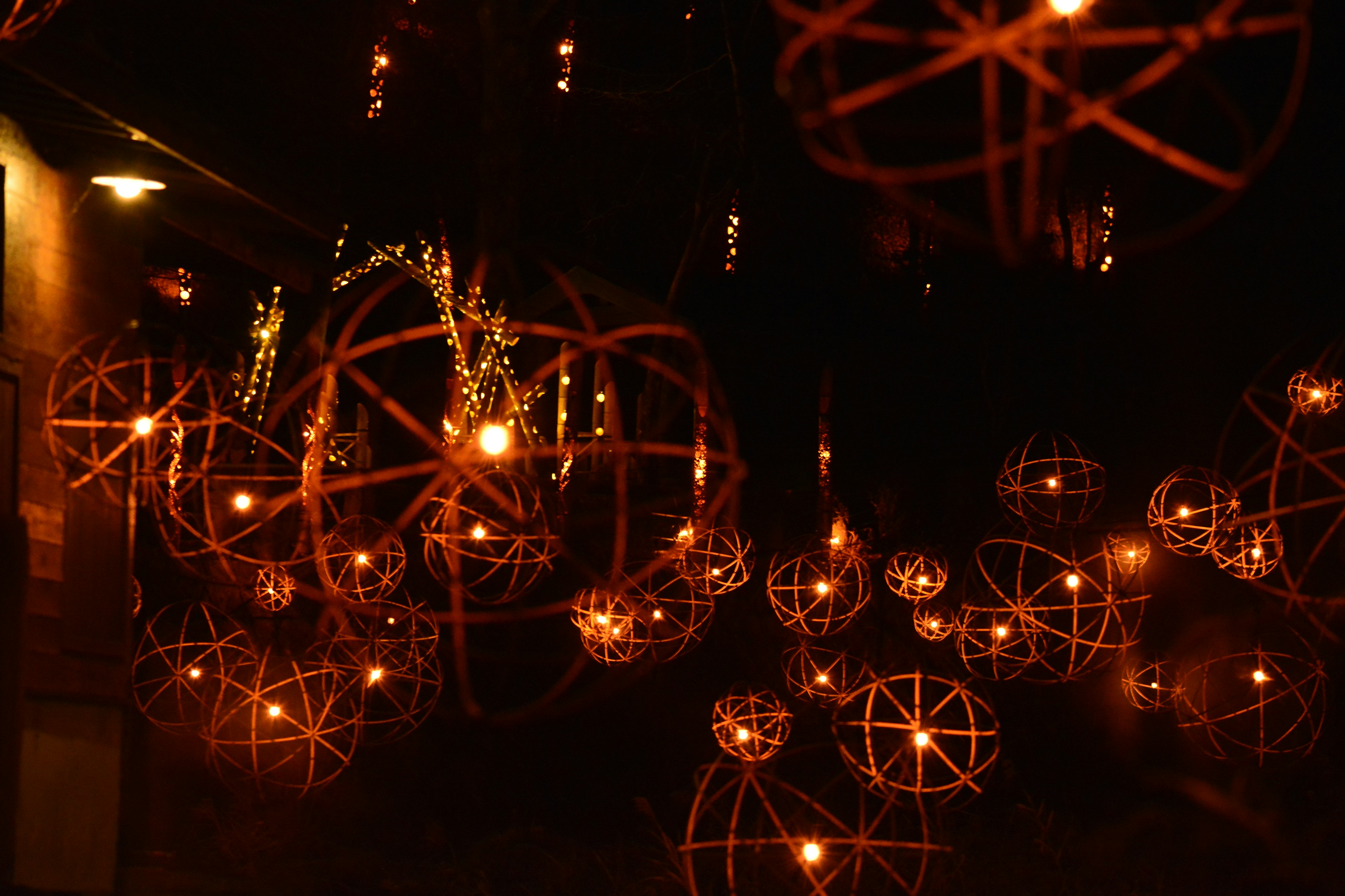 Decorative hanging lamps emitting warm light against a dark background