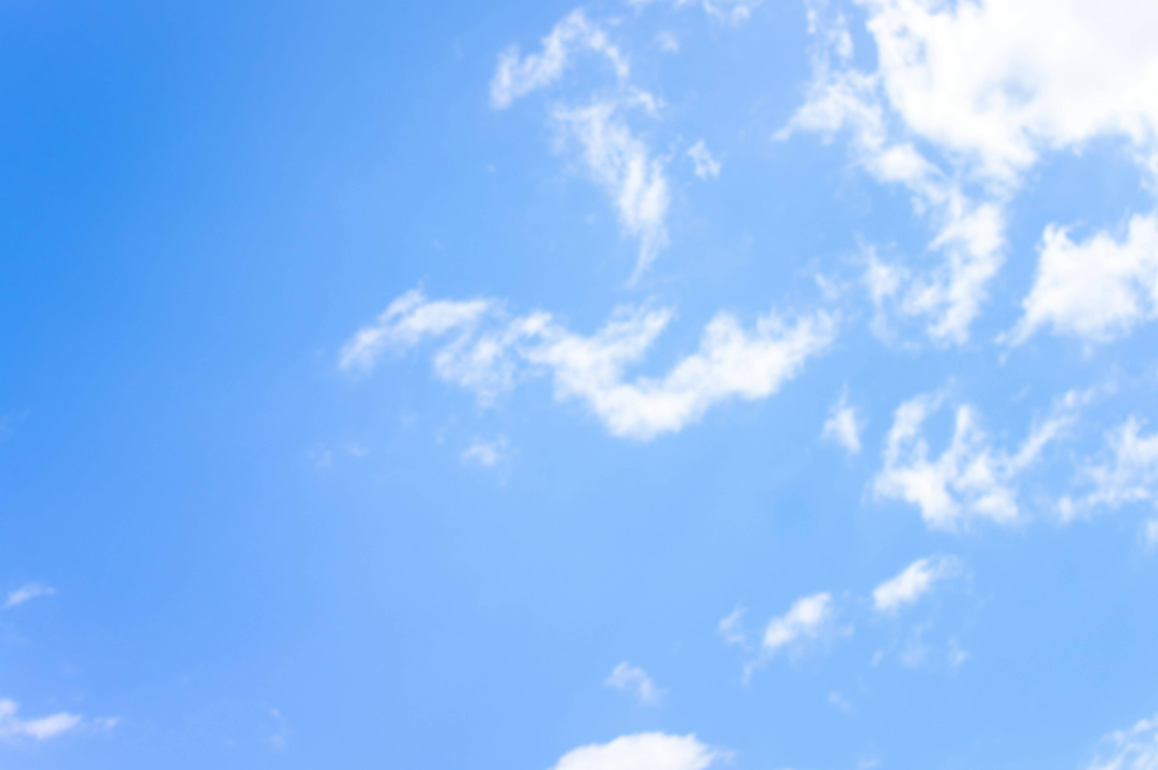 Vast blue sky with fluffy white clouds