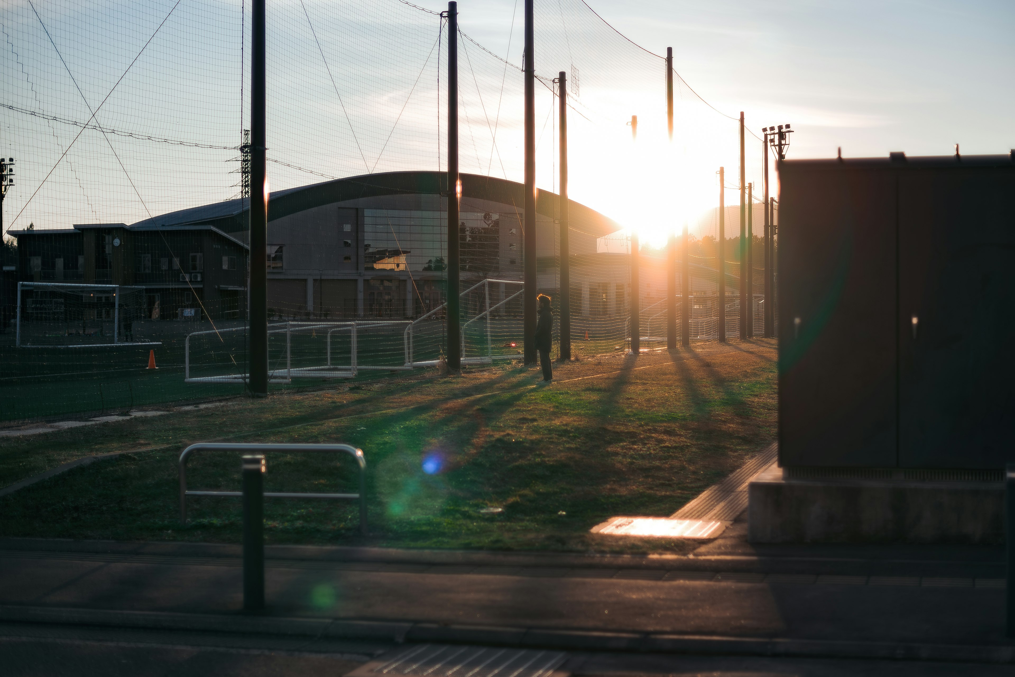 Sunset behind a soccer field with long shadows