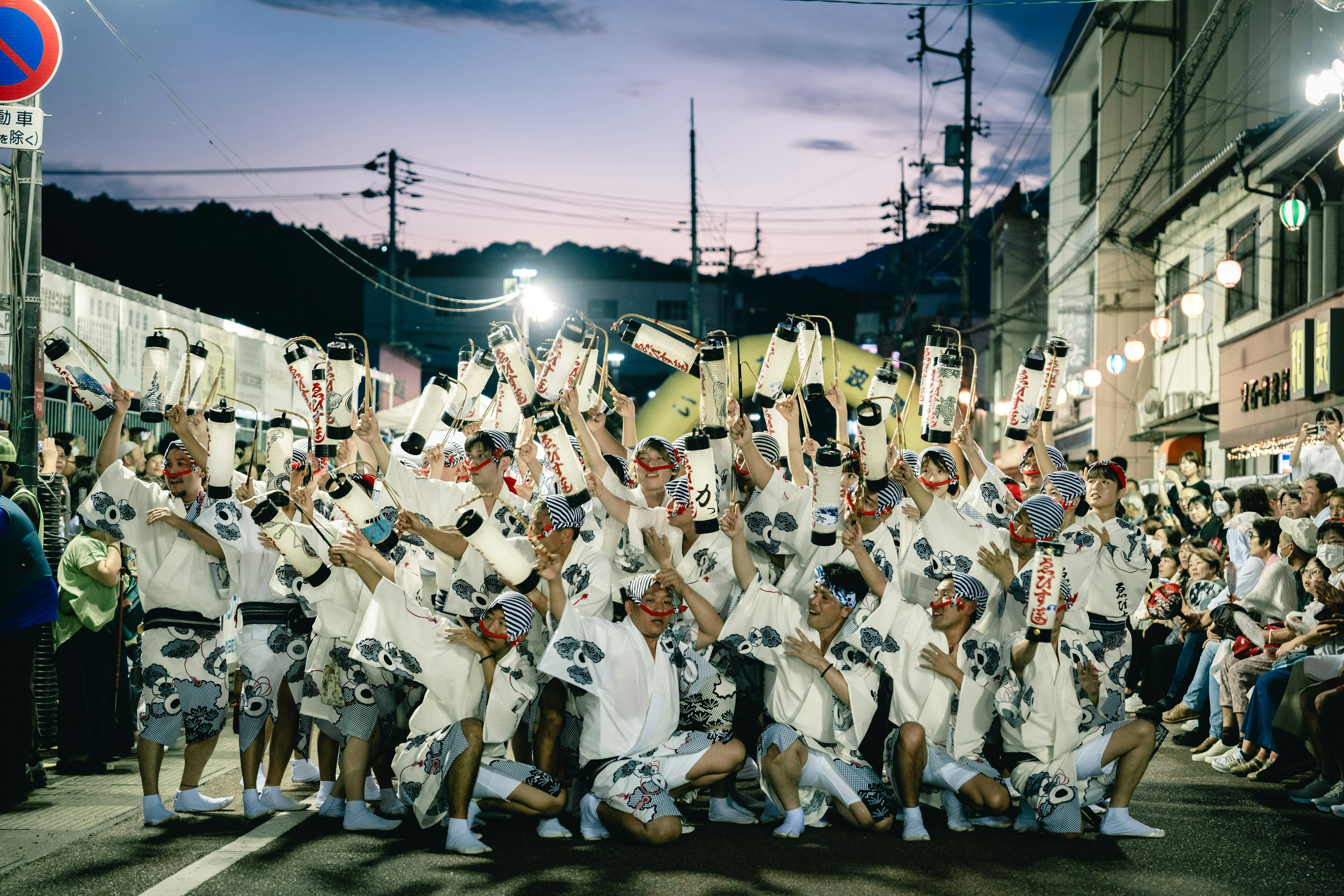 Festival participants striking a pose in a night street scene