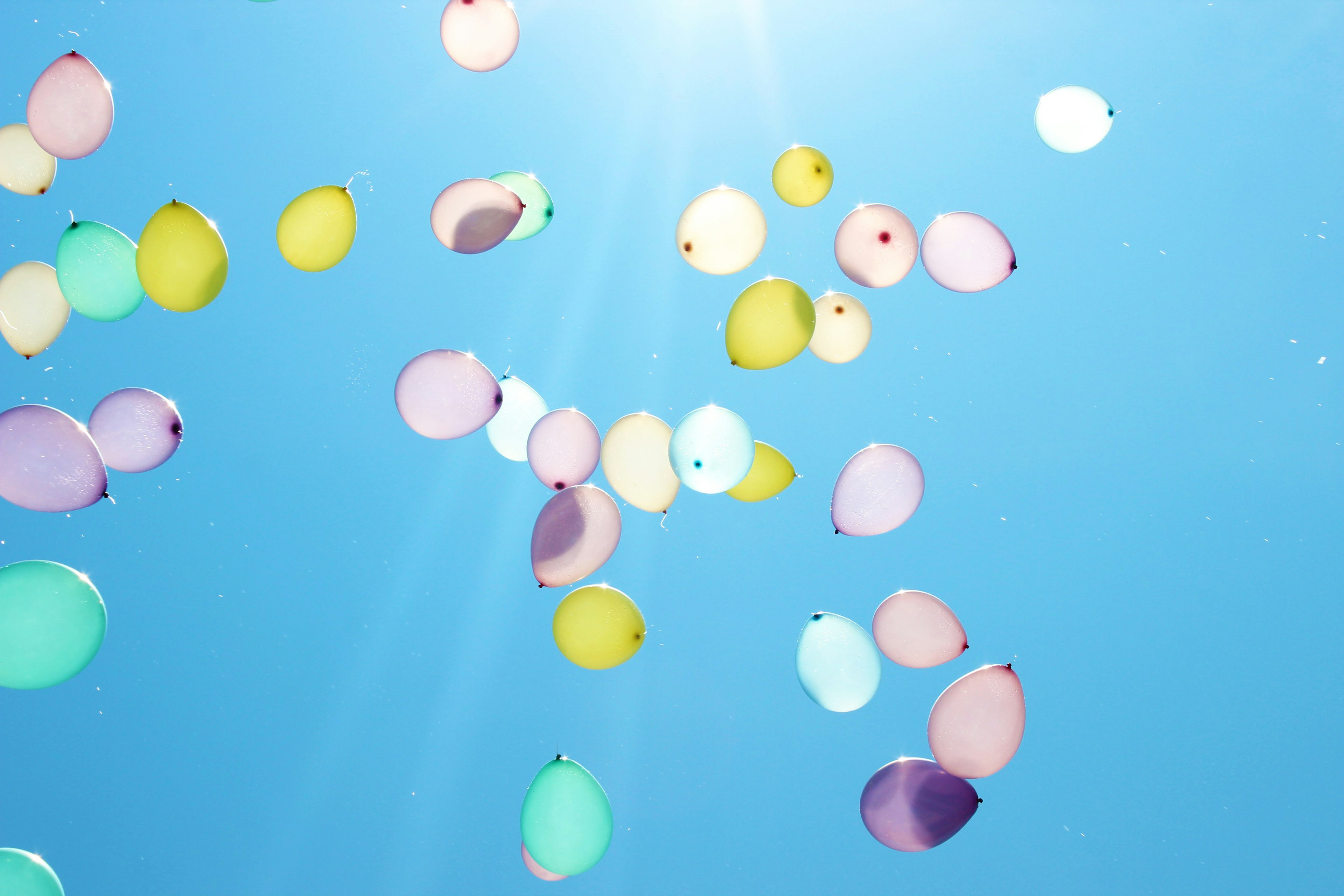 Colorful balloons floating in a blue sky