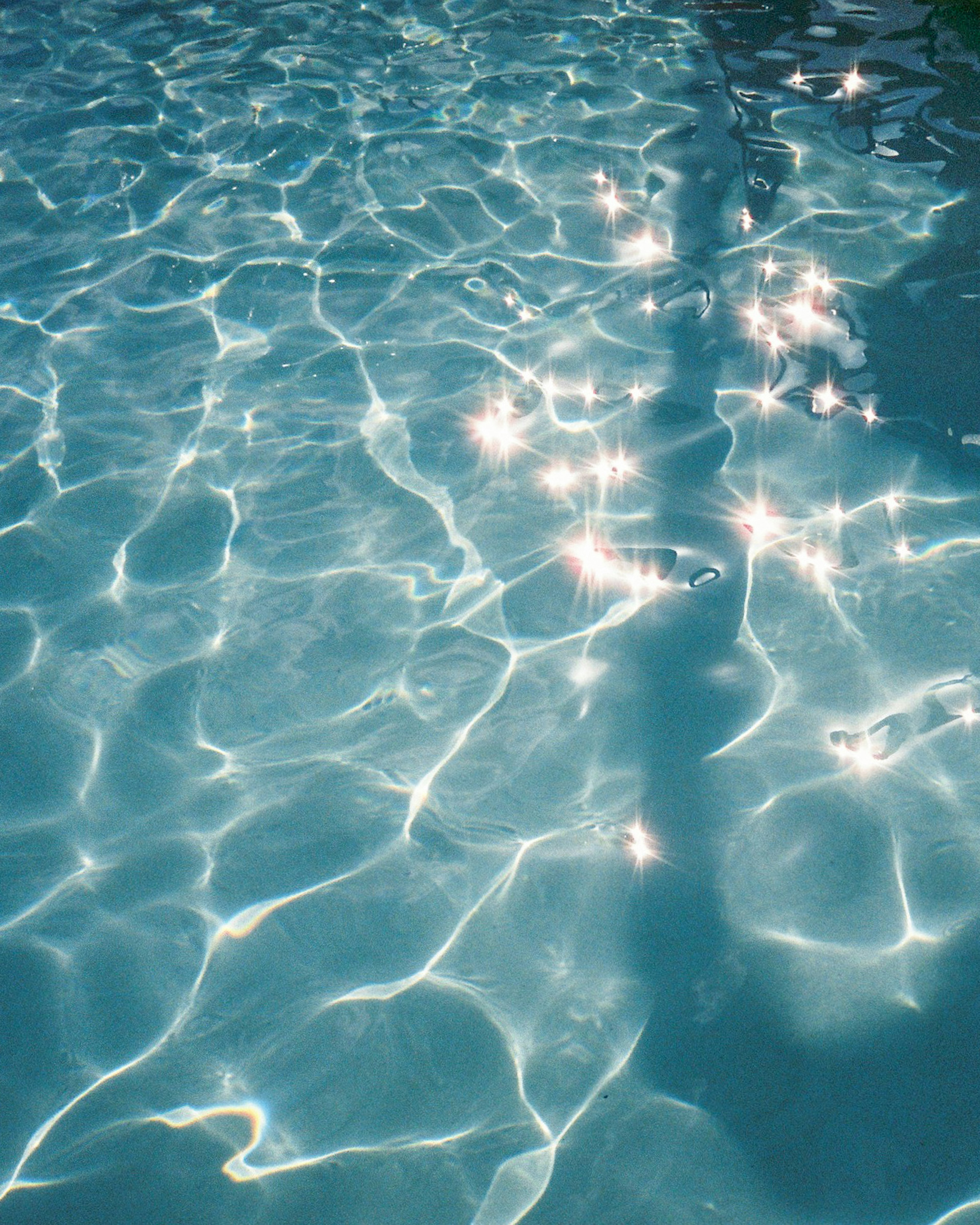 Sunlight sparkling on the surface of water with ripples