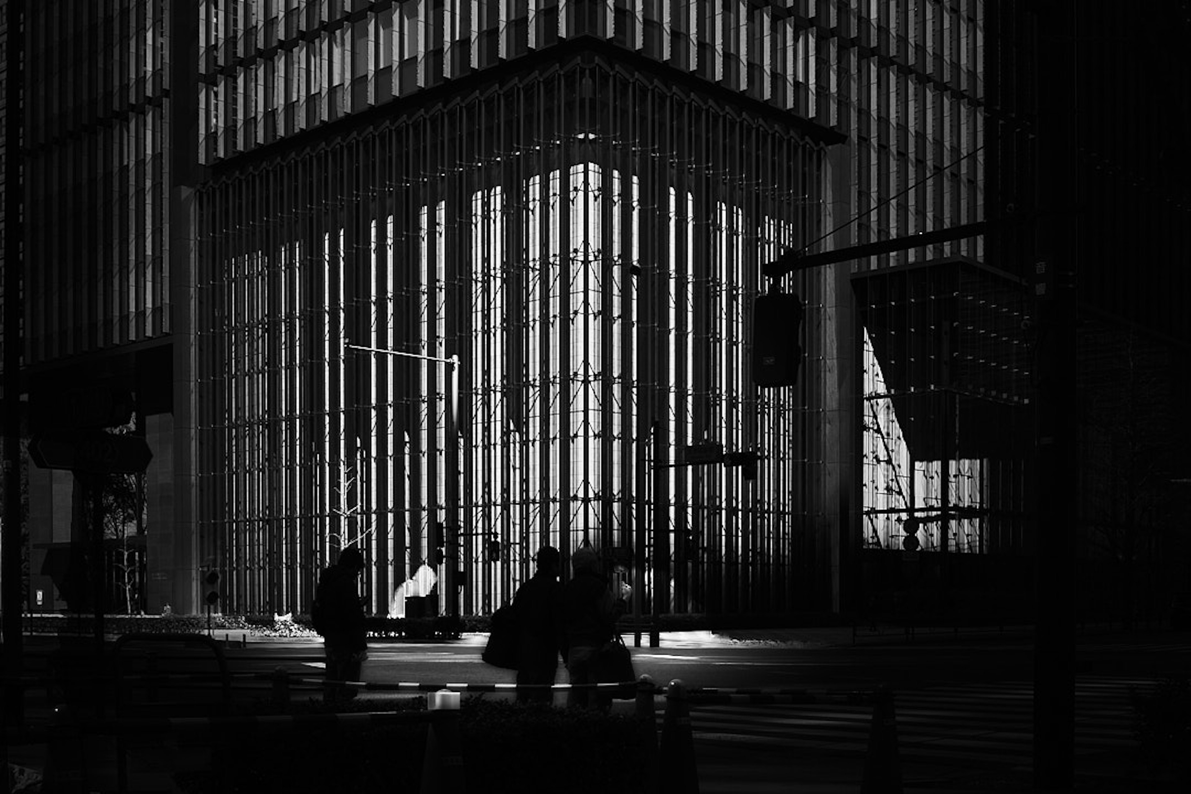 Modern building facade with striking black and white contrast and pedestrians