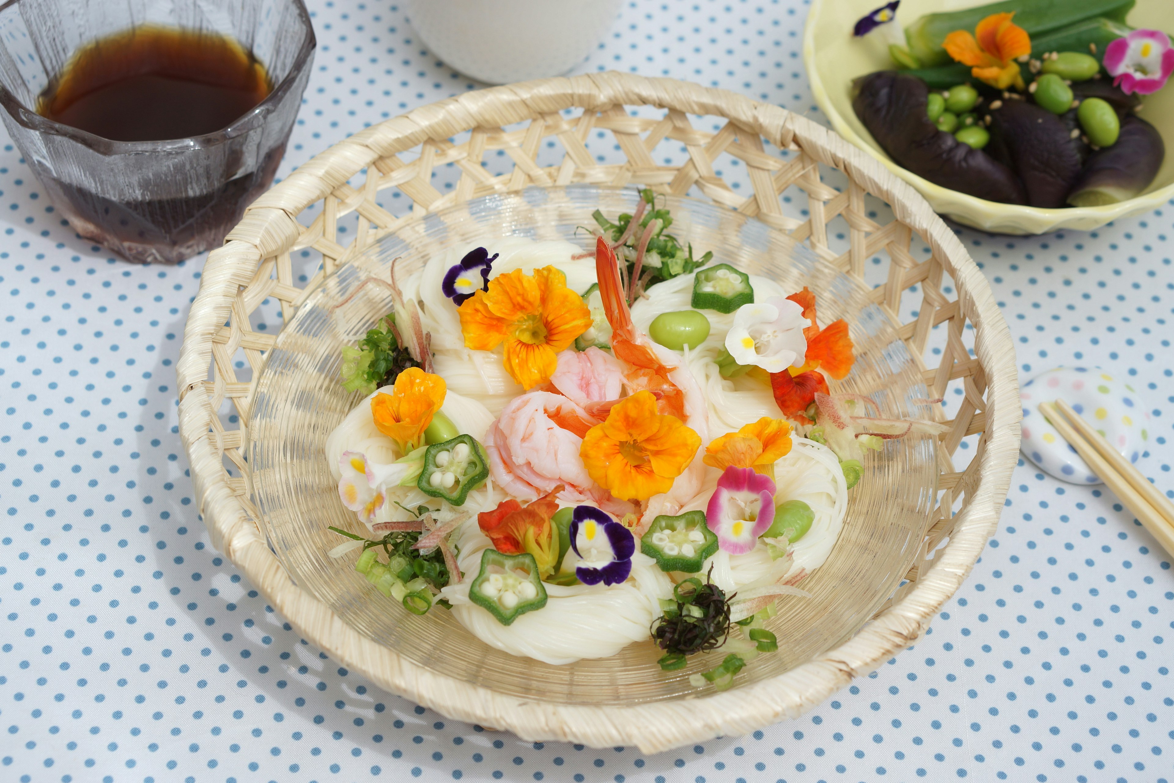 Beautifully arranged Japanese dish with colorful flowers and vegetables