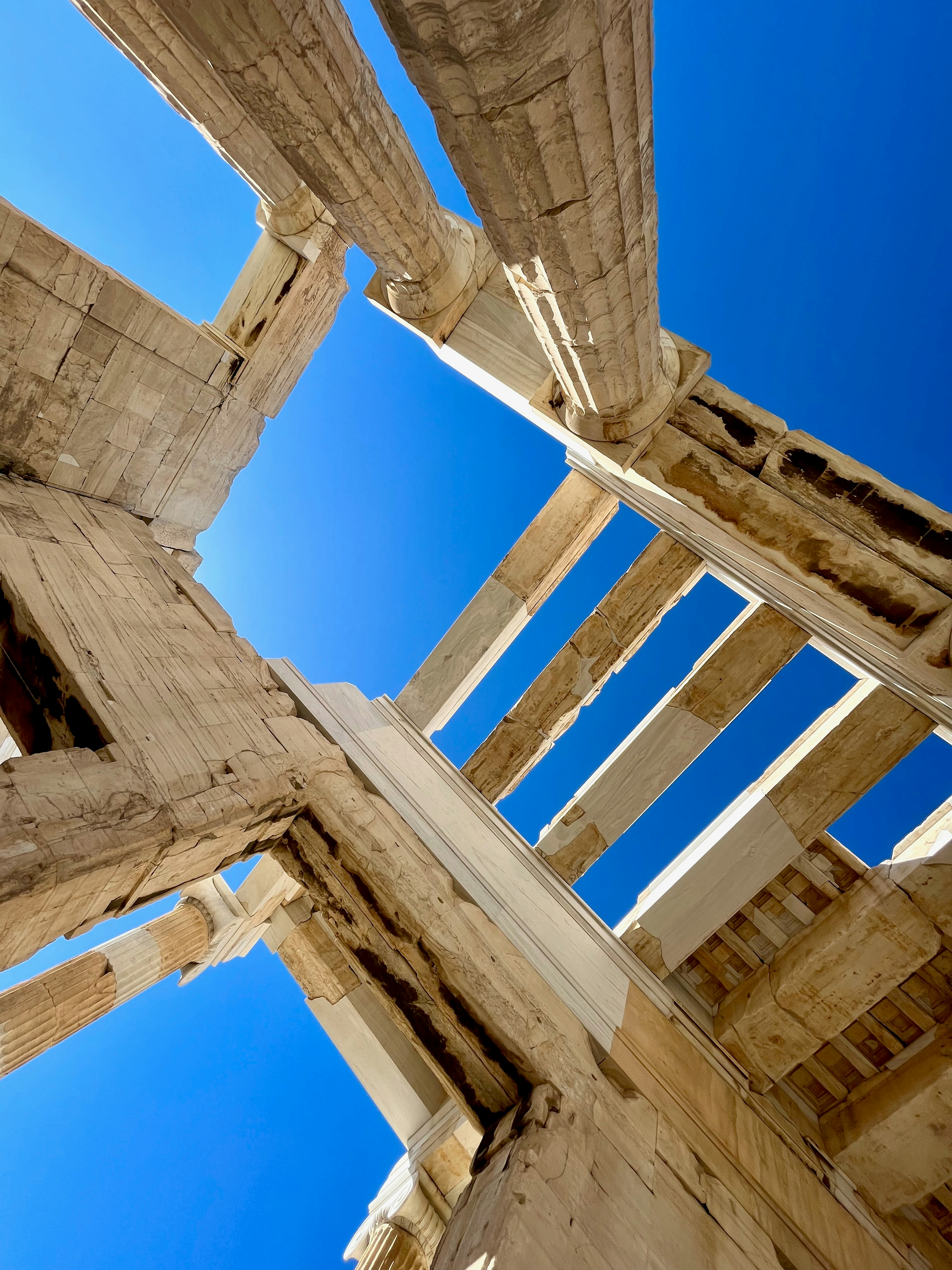 View of ancient architecture from below with a blue sky background