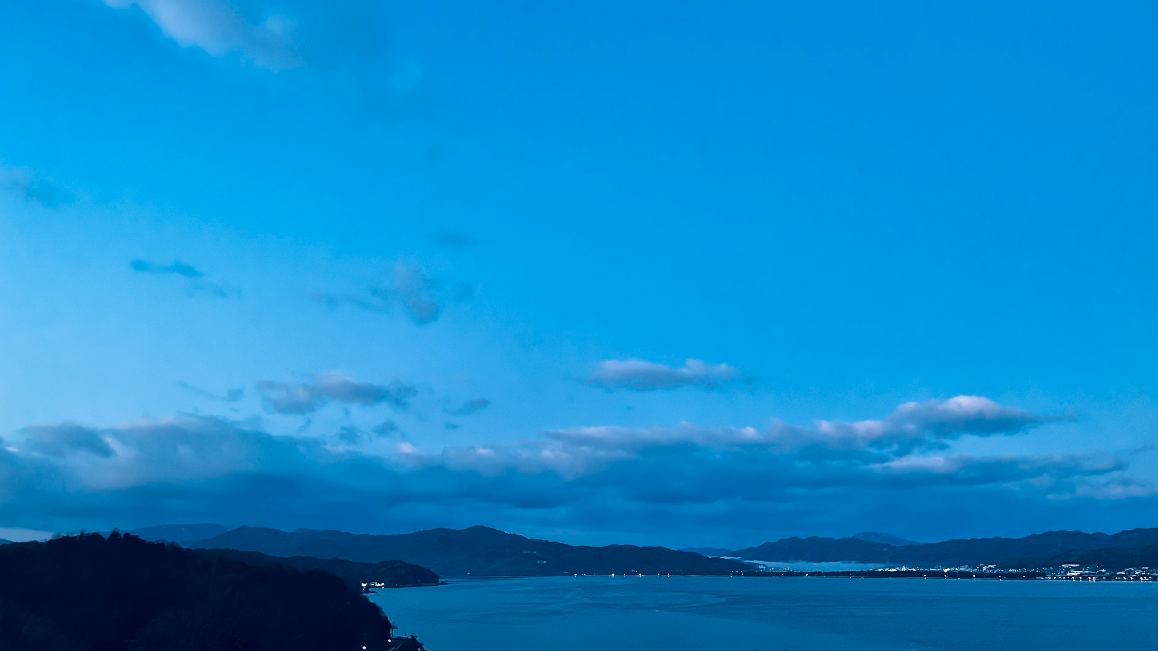 Scenic view of a blue sky with clouds over the water