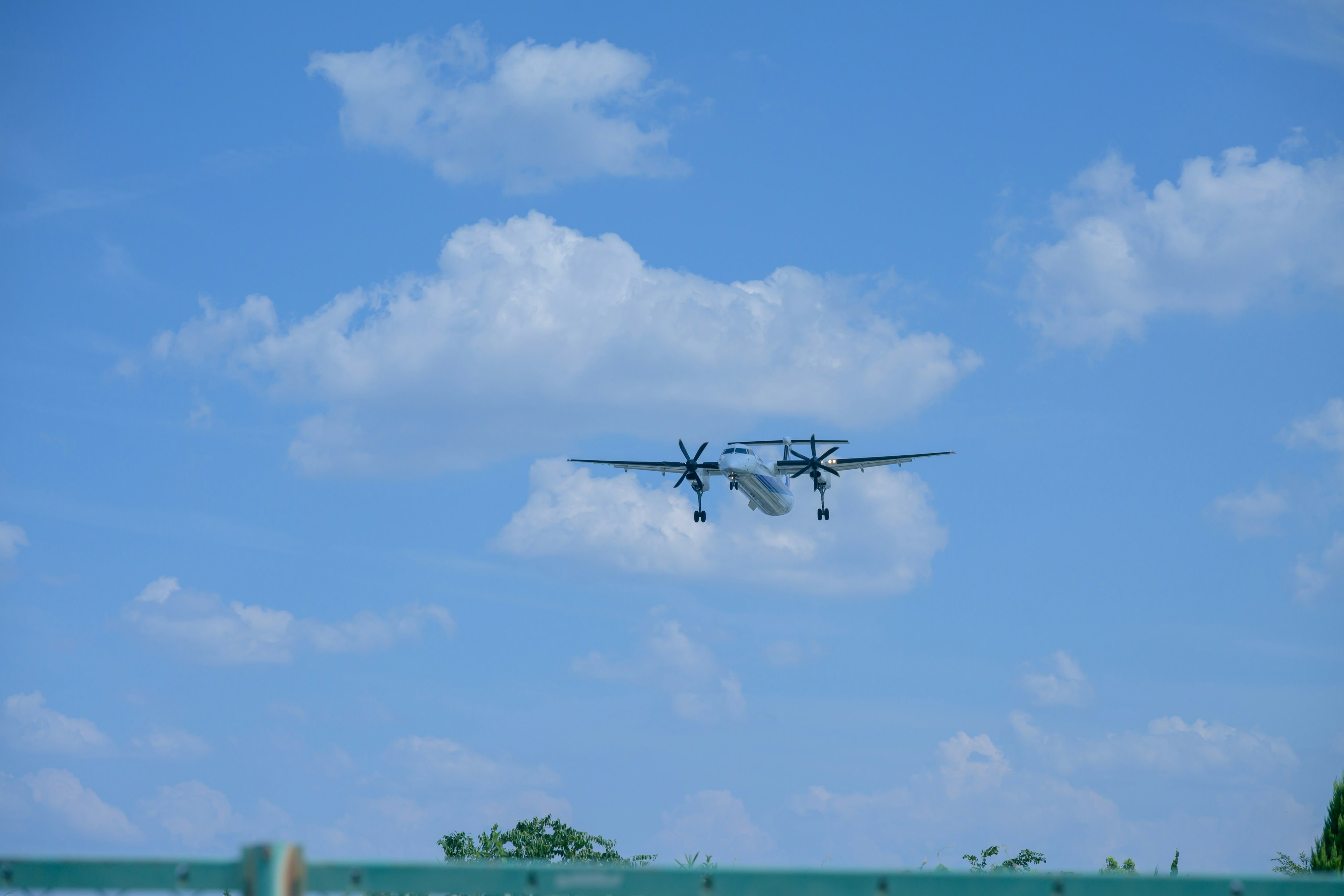 Twin-engine airplane flying in a blue sky