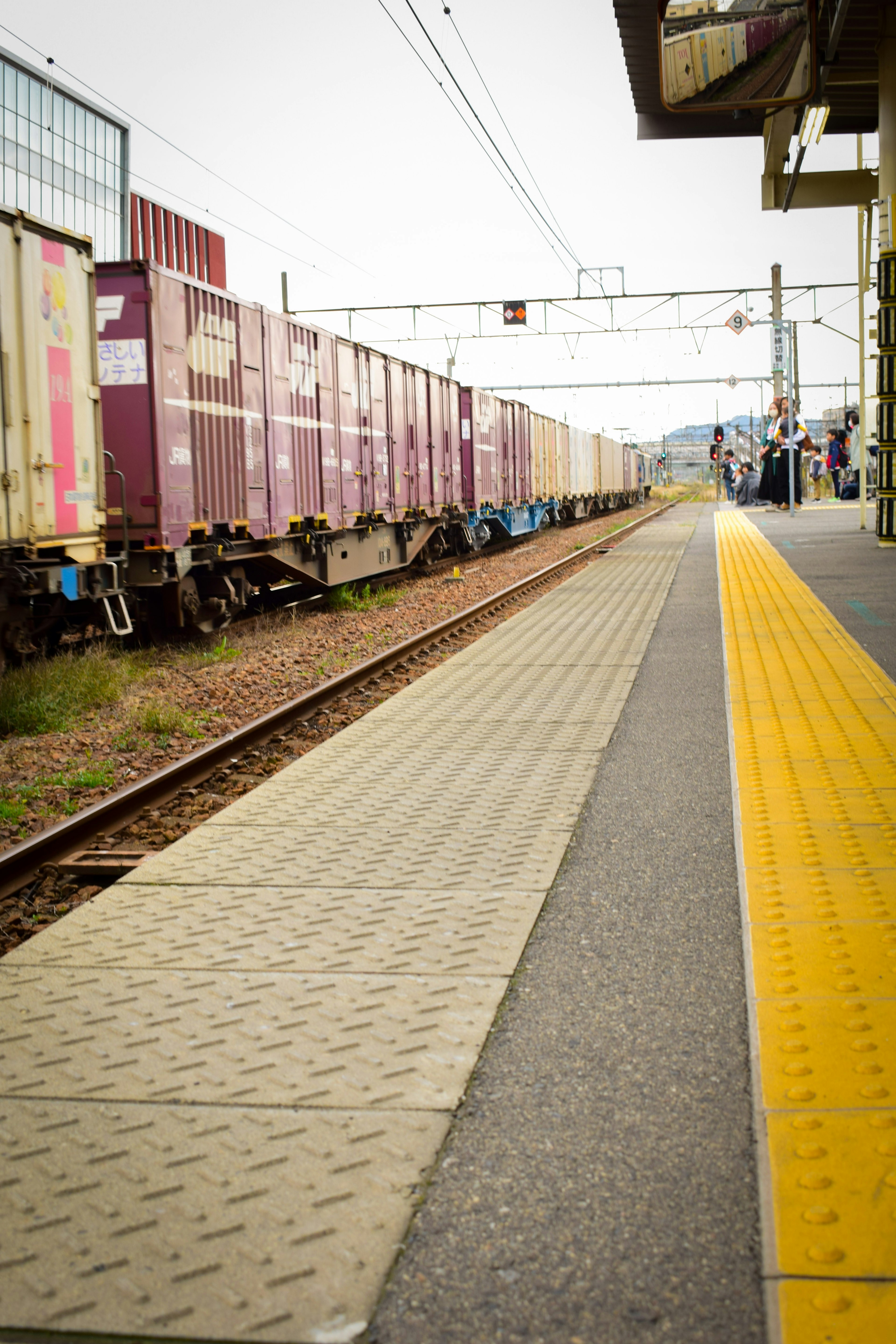 Vista di un treno merci in una stazione con un marciapiede