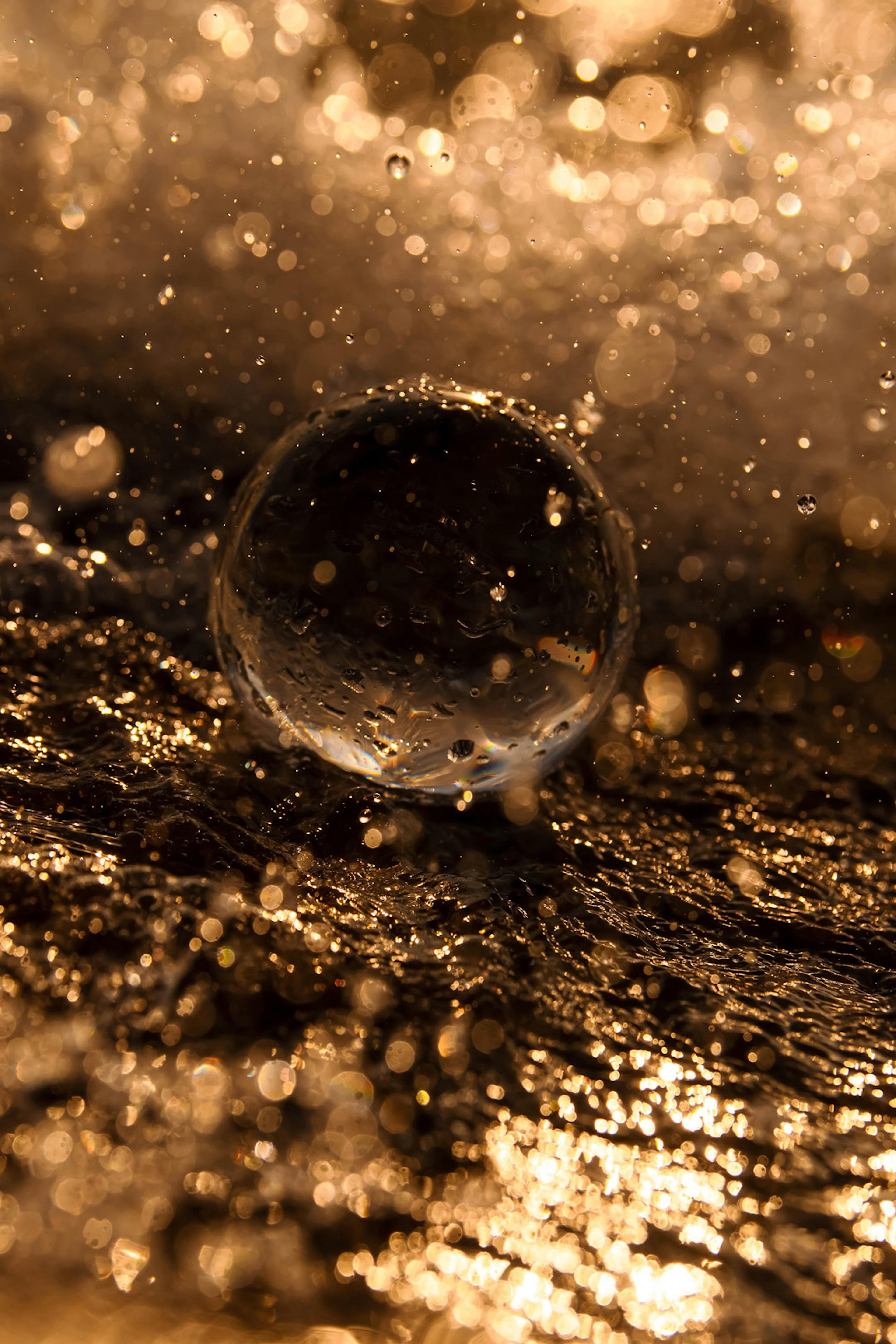 A spherical object in water with splashes creating a captivating scene