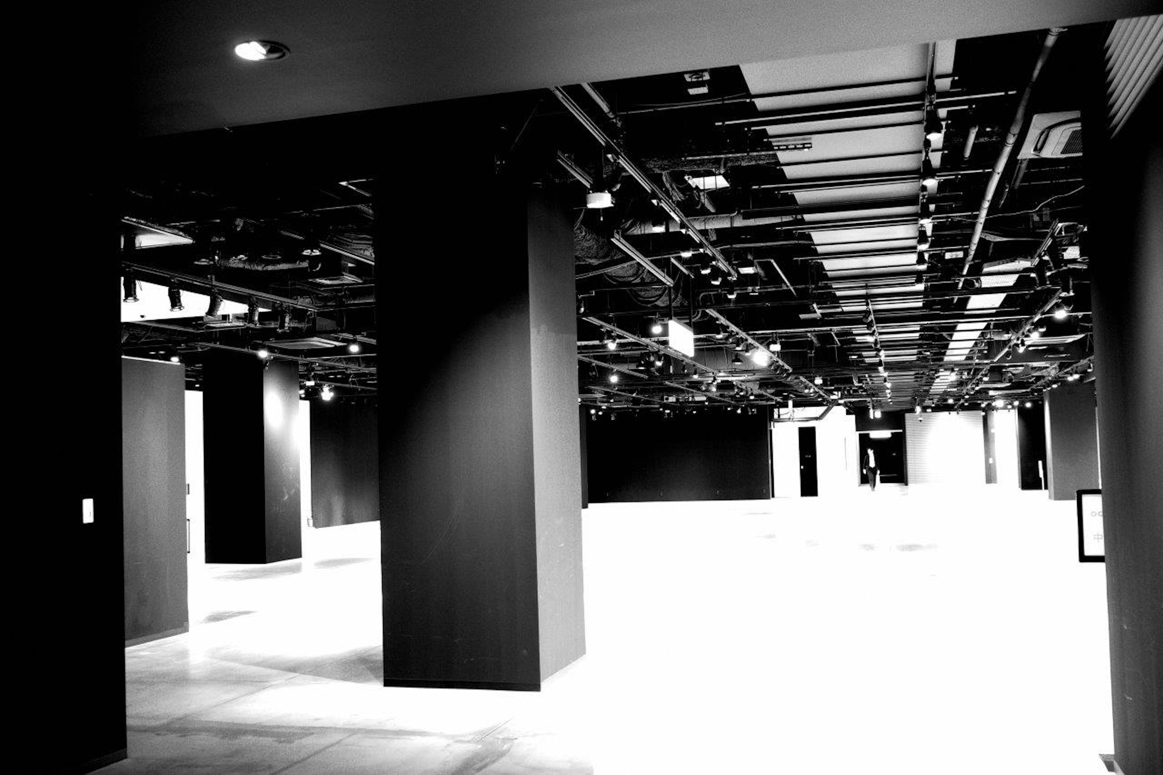 Interior of a modern exhibition space featuring black and white contrast