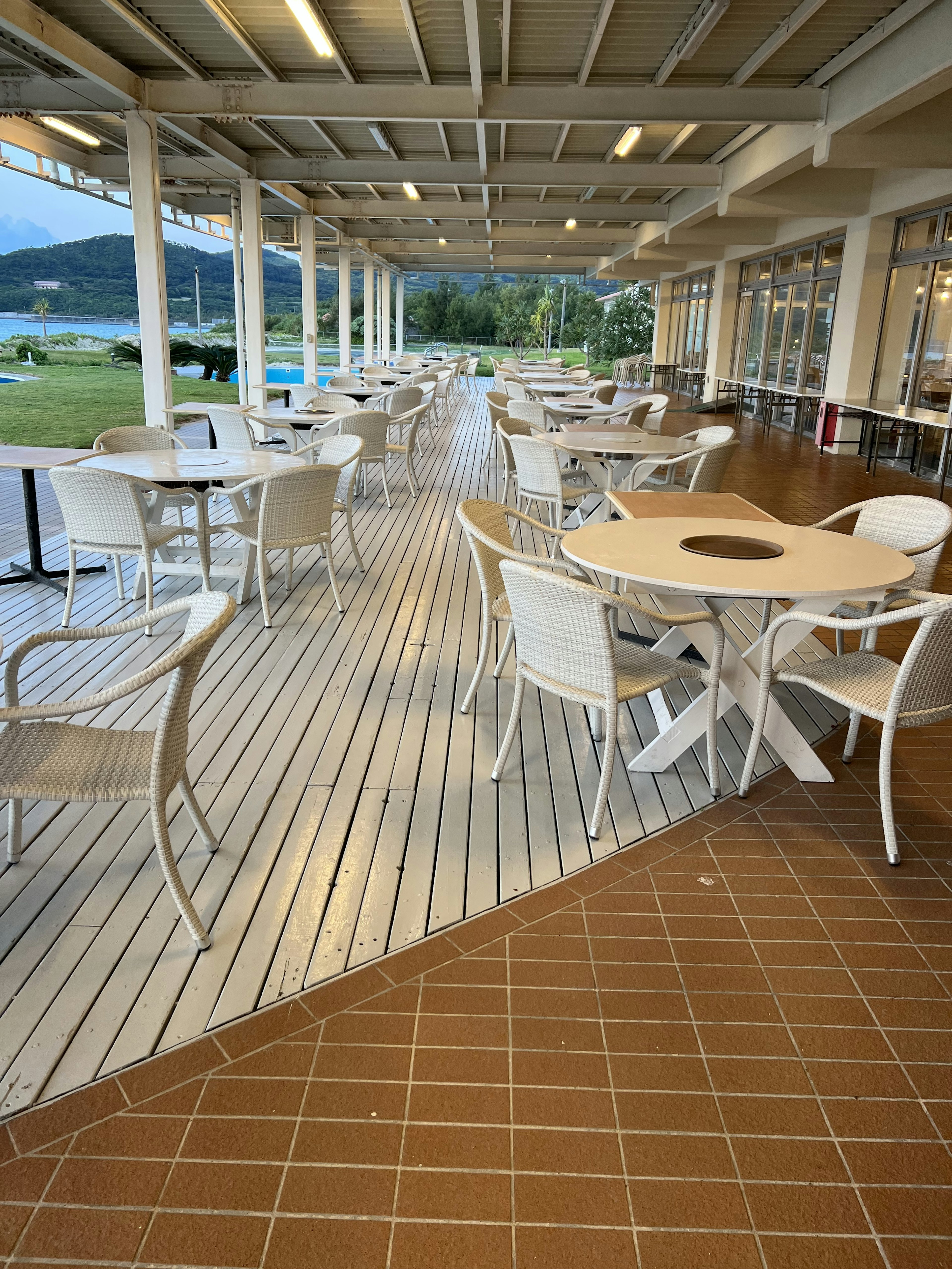 Restaurant terrace with white chairs and tables