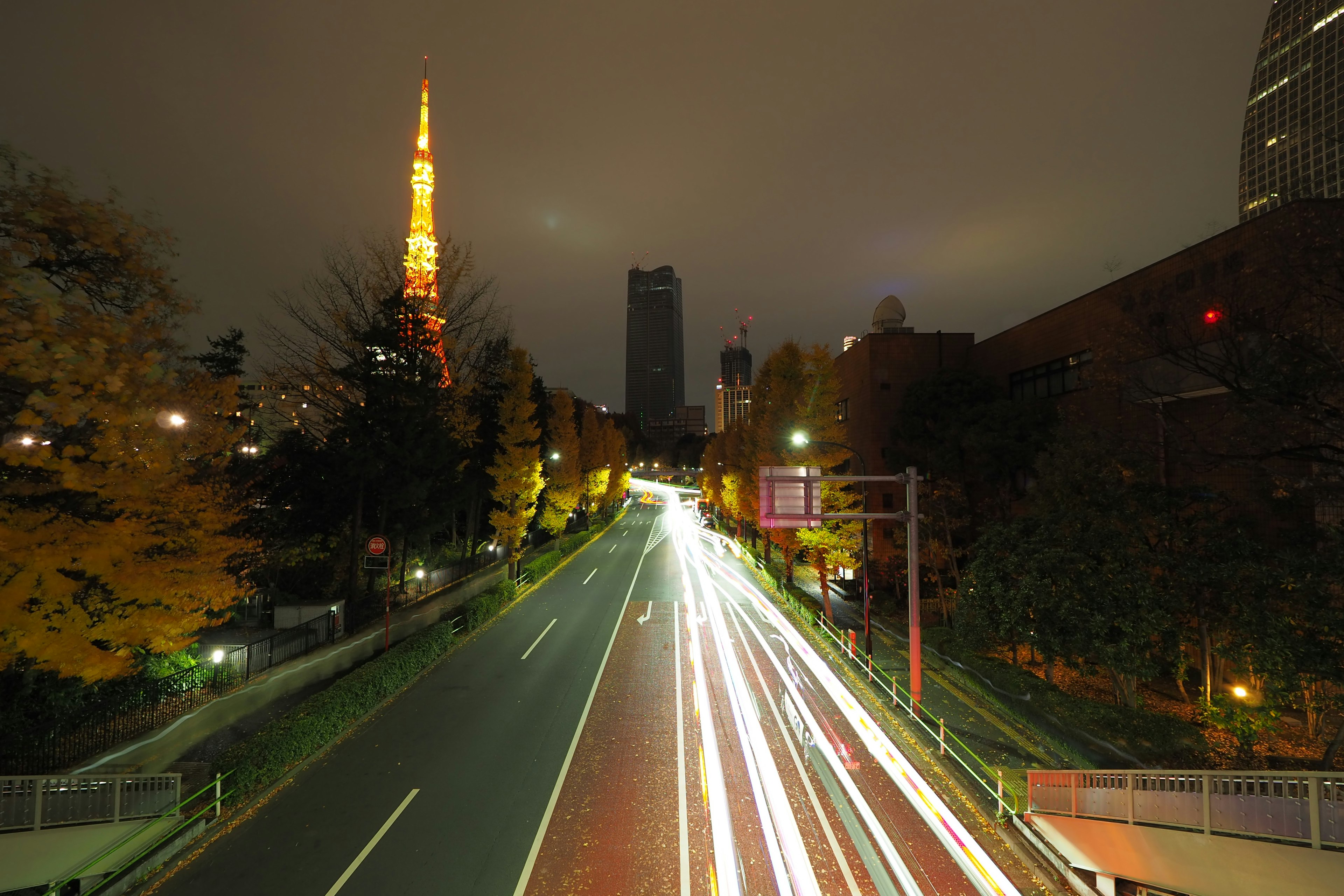 Long exposure photo of a road with Tokyo Tower and city skyline at night