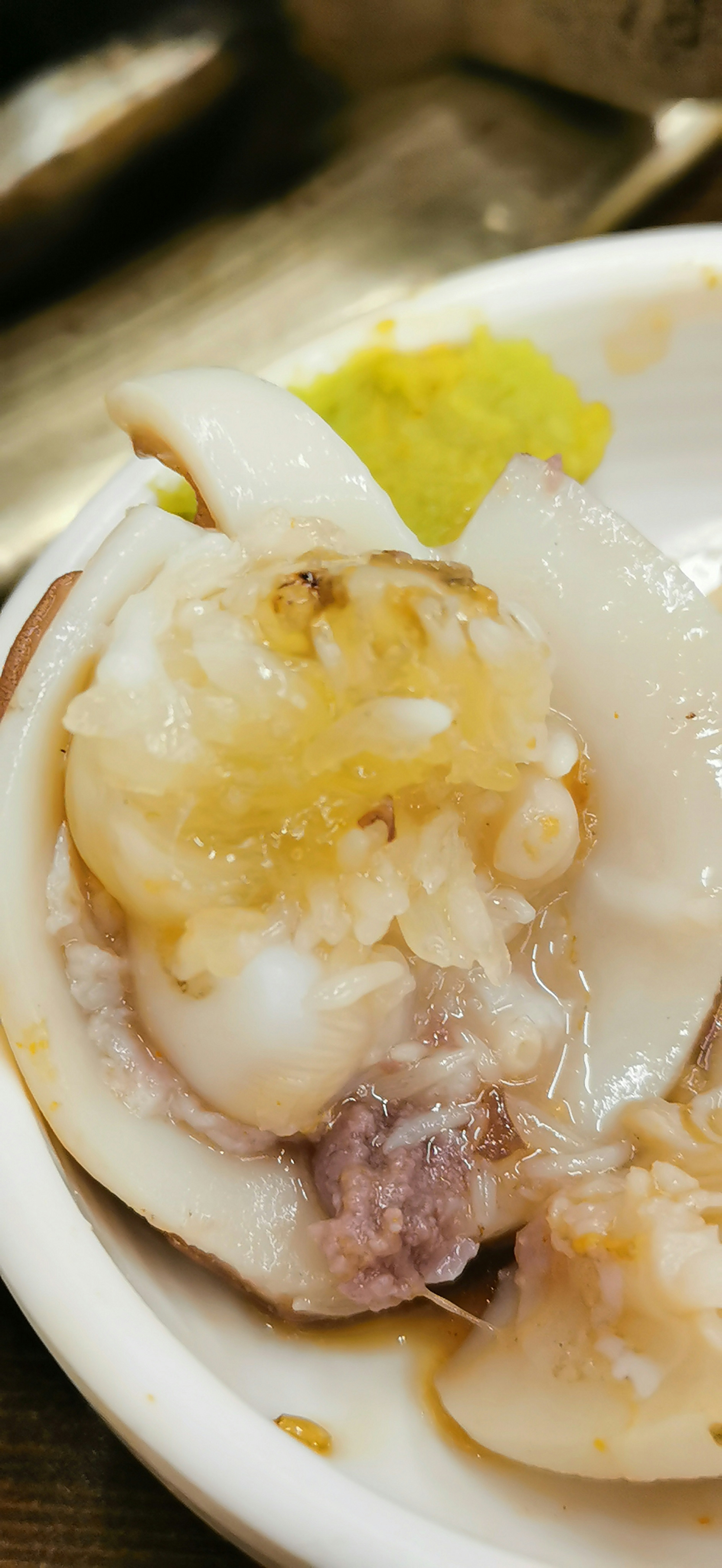 Fresh shellfish served on a white plate with wasabi